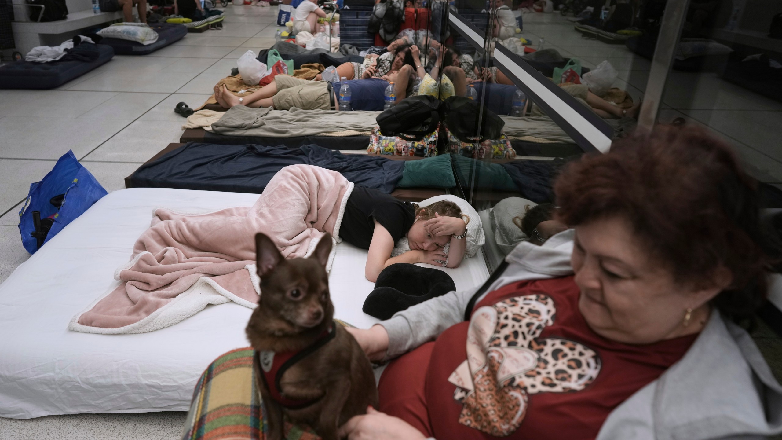 People take shelter in an underground metro station as a precaution against possible Iran missile attacks, in Ramat Gan, near Tel Aviv, Israel, Tuesday, June 17, 2025. (AP Photo/Oded Balilty)