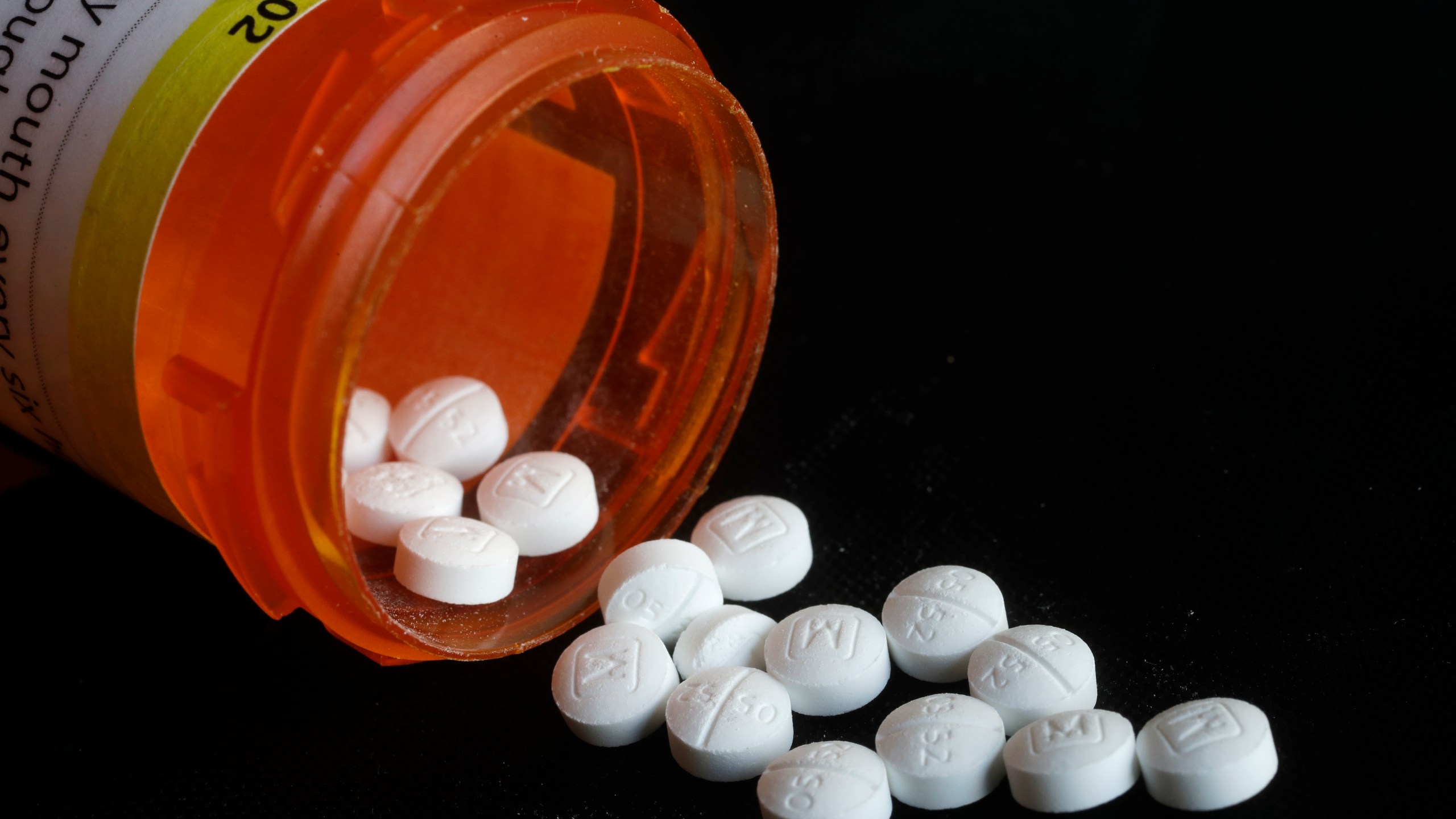 FILE - Pills spill in an arrangement photo of prescription Oxycodone in New York. (AP Photo/Mark Lennihan, File)