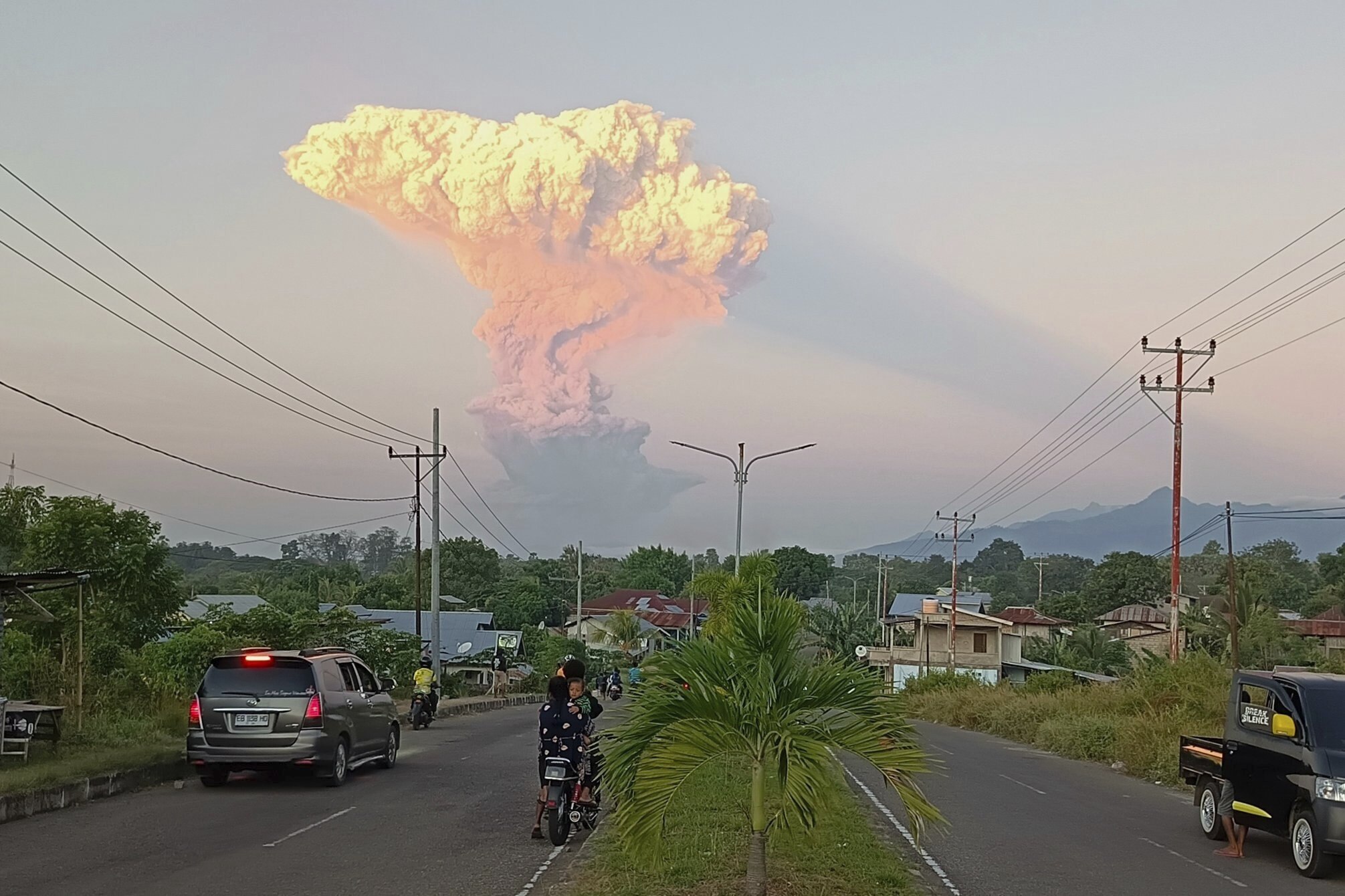 People watch as Mount Lewotobi Laki-Laki spews volcanic materials into the air during an eruption, in Maumere, Indonesia, Tuesday, June 17, 2025. (AP Photo)