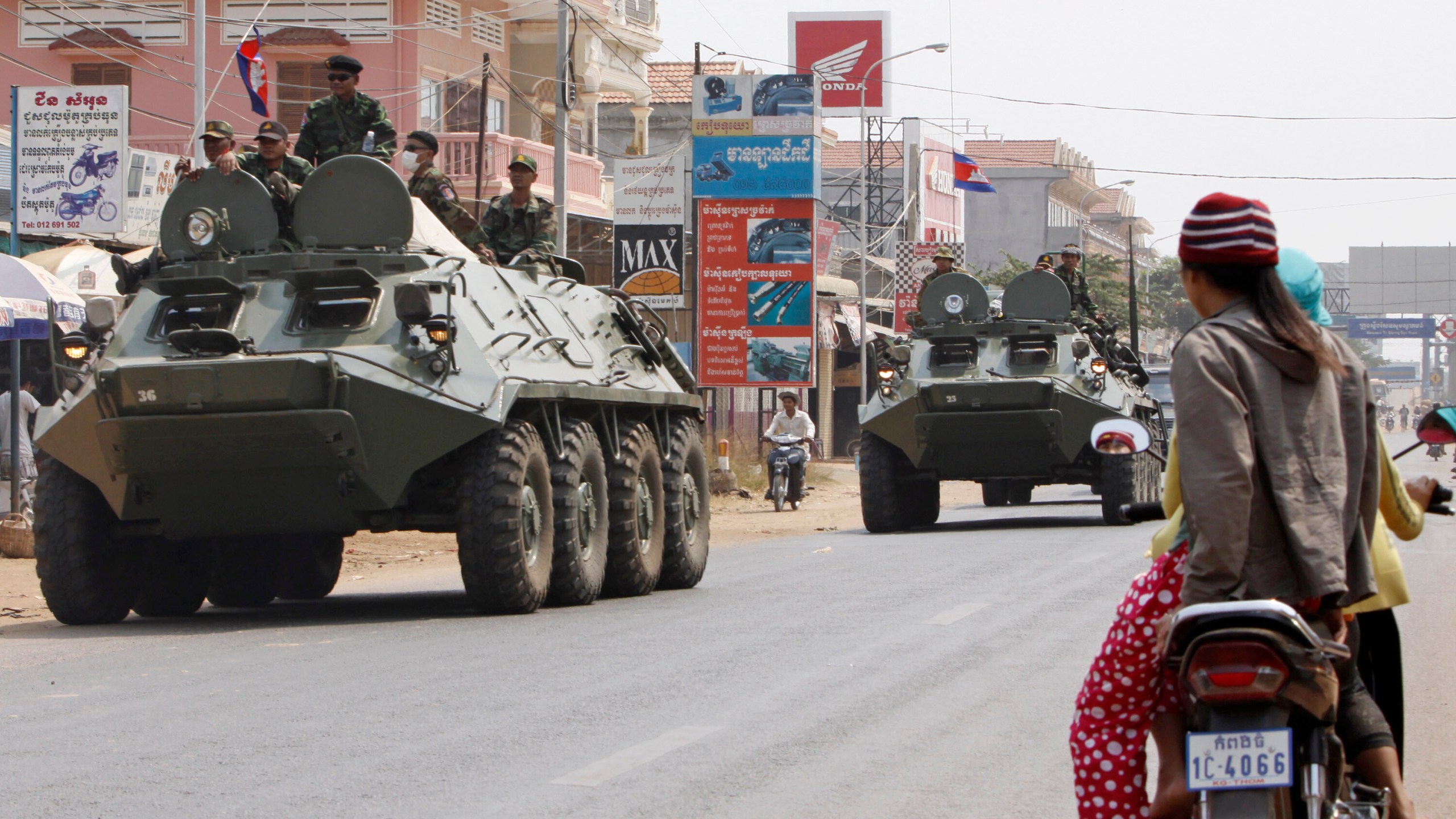 FILE- Armored personnel carriers of Cambodian Army drive through a road at Kampong Thom town, about 168 kilometers (104 mikes) north of Phnom Penh, Cambodia, Saturday, Feb. 12, 2011. (AP Photo/Heng Sinith, File)