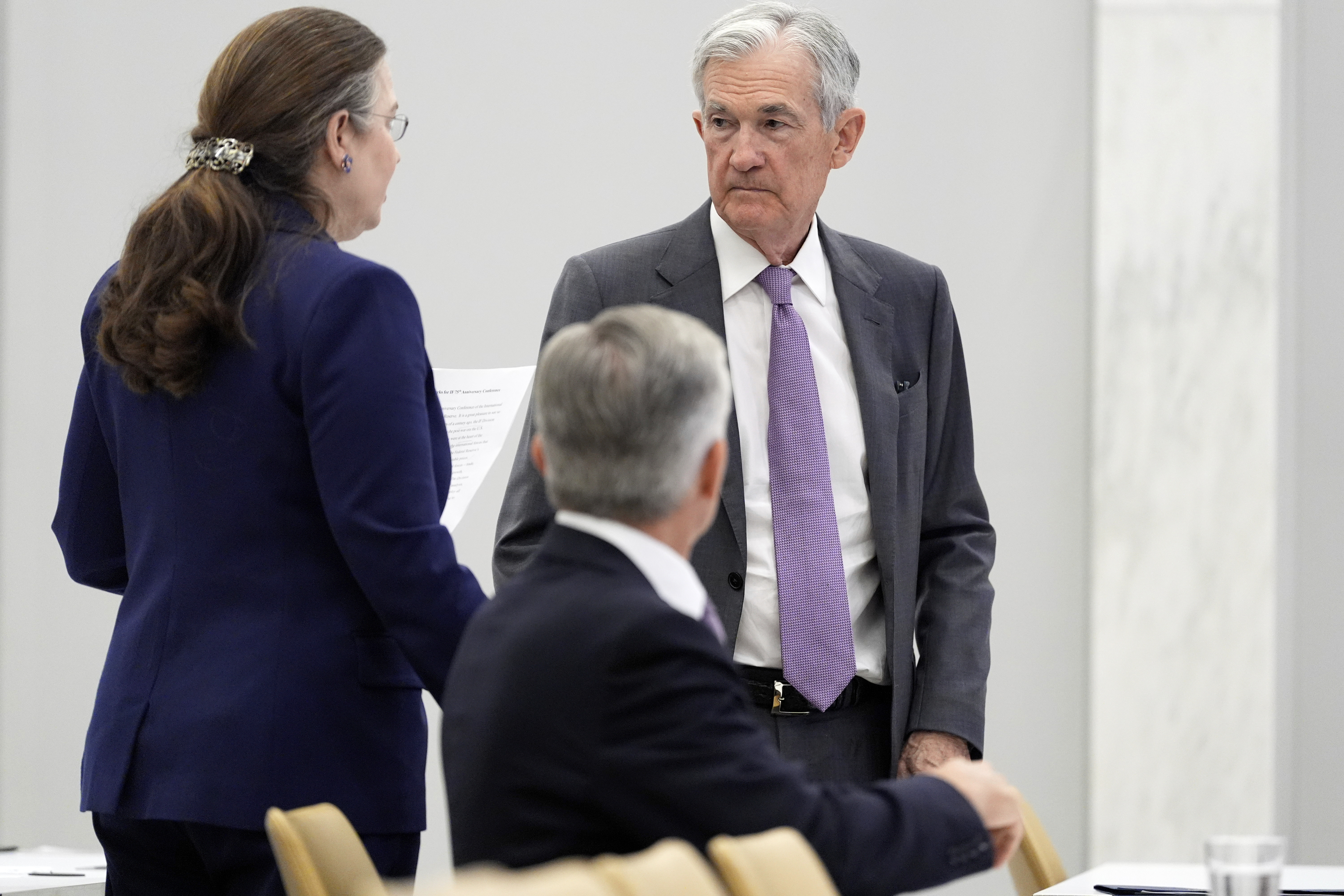 Federal Reserve Chairman Jerome Powell, right, stands before speaking at the 75th anniversary conference of the Federal Reserve Board's International Finance Division at the Federal Reserve in Washington, Monday, June 2, 2025. (AP Photo/Mark Schiefelbein)