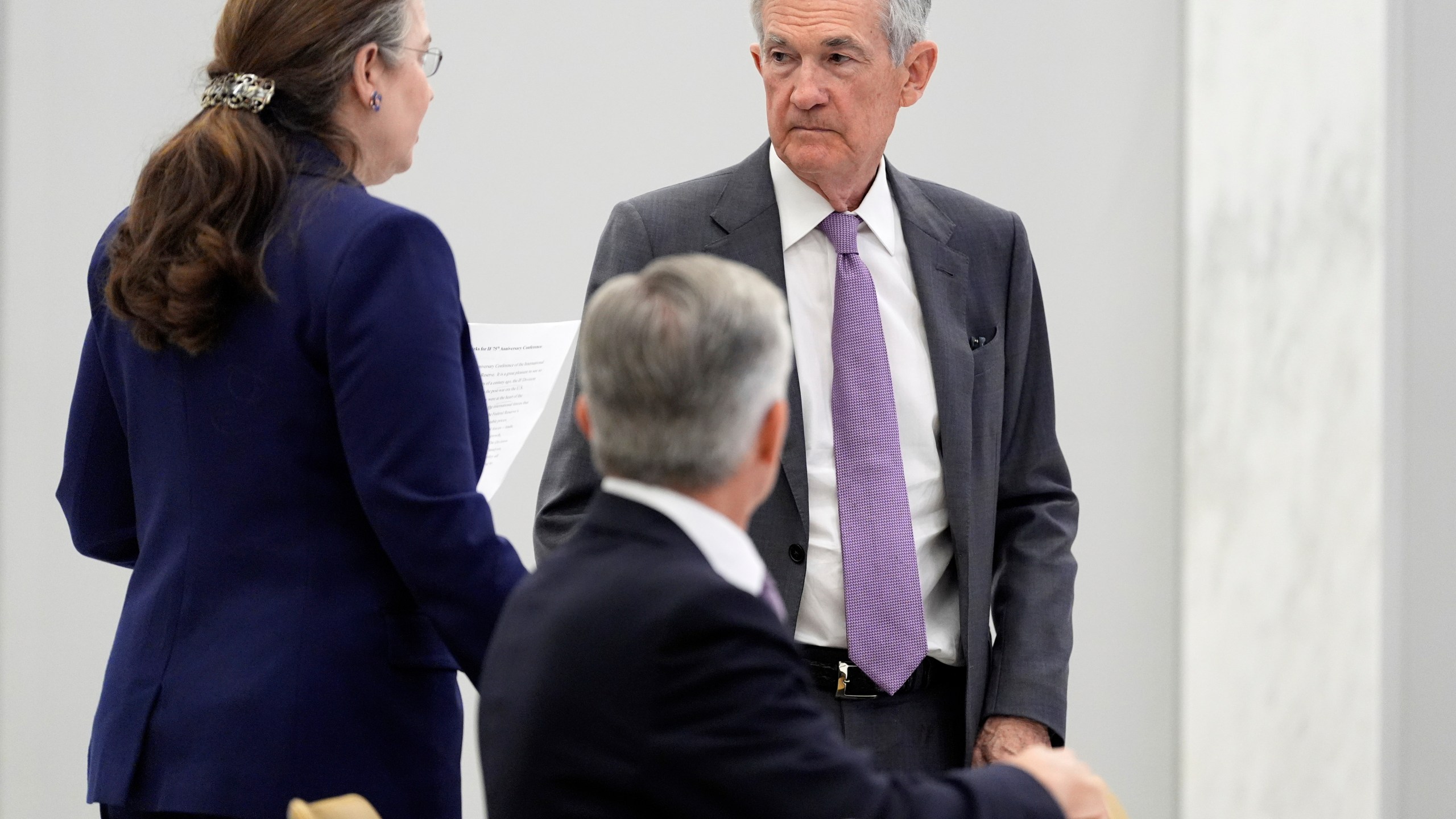 Federal Reserve Chairman Jerome Powell, right, stands before speaking at the 75th anniversary conference of the Federal Reserve Board's International Finance Division at the Federal Reserve in Washington, Monday, June 2, 2025. (AP Photo/Mark Schiefelbein)
