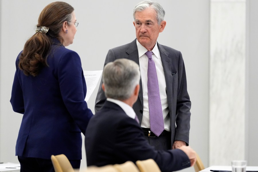 Federal Reserve Chairman Jerome Powell, right, stands before speaking at the 75th anniversary conference of the Federal Reserve Board's International Finance Division at the Federal Reserve in Washington, Monday, June 2, 2025. (AP Photo/Mark Schiefelbein)