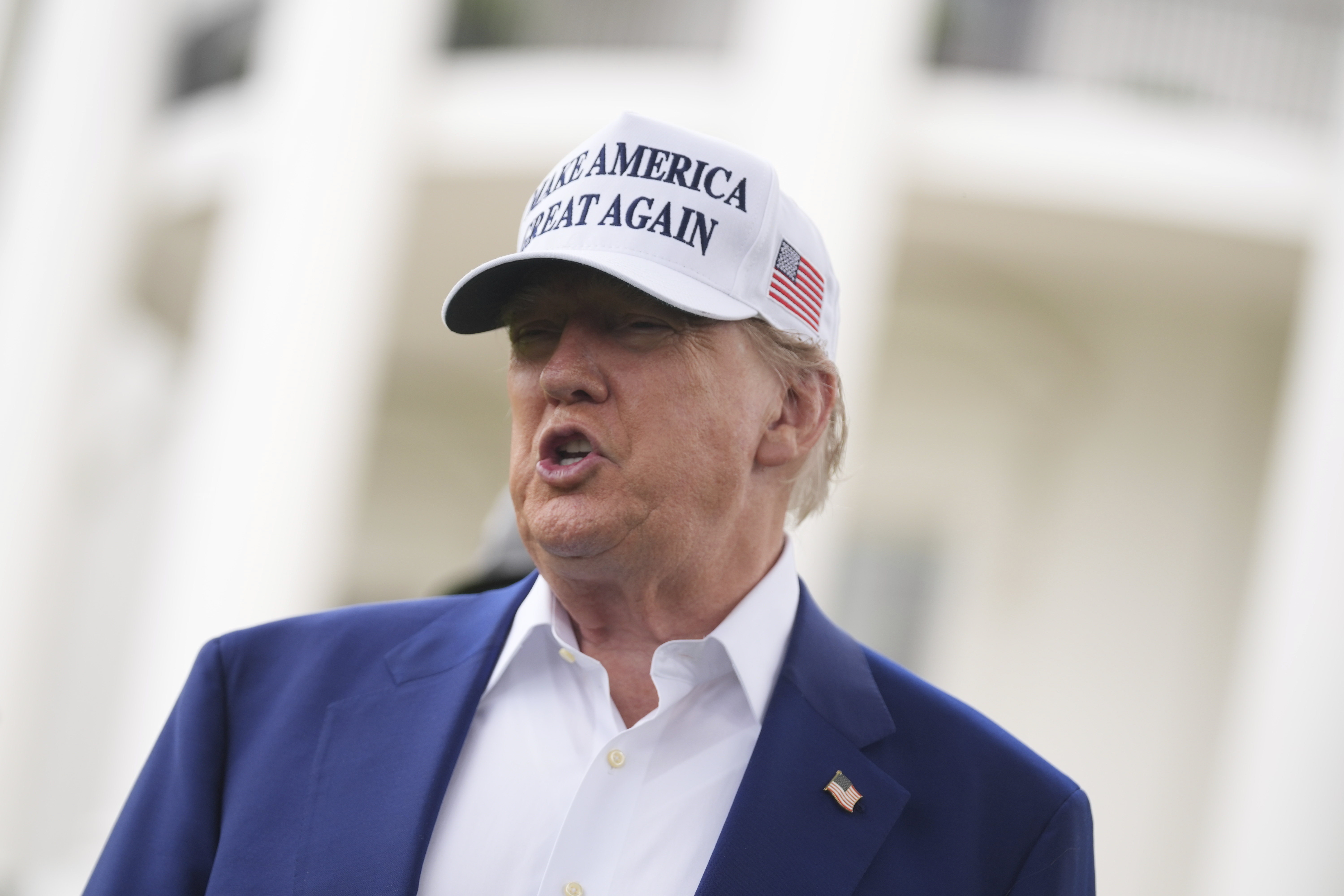 President Donald Trump speaks as a flag pole is installed on the South Lawn of the White House, Wednesday, June 18, 2025, in Washington. (AP Photo/Evan Vucci)