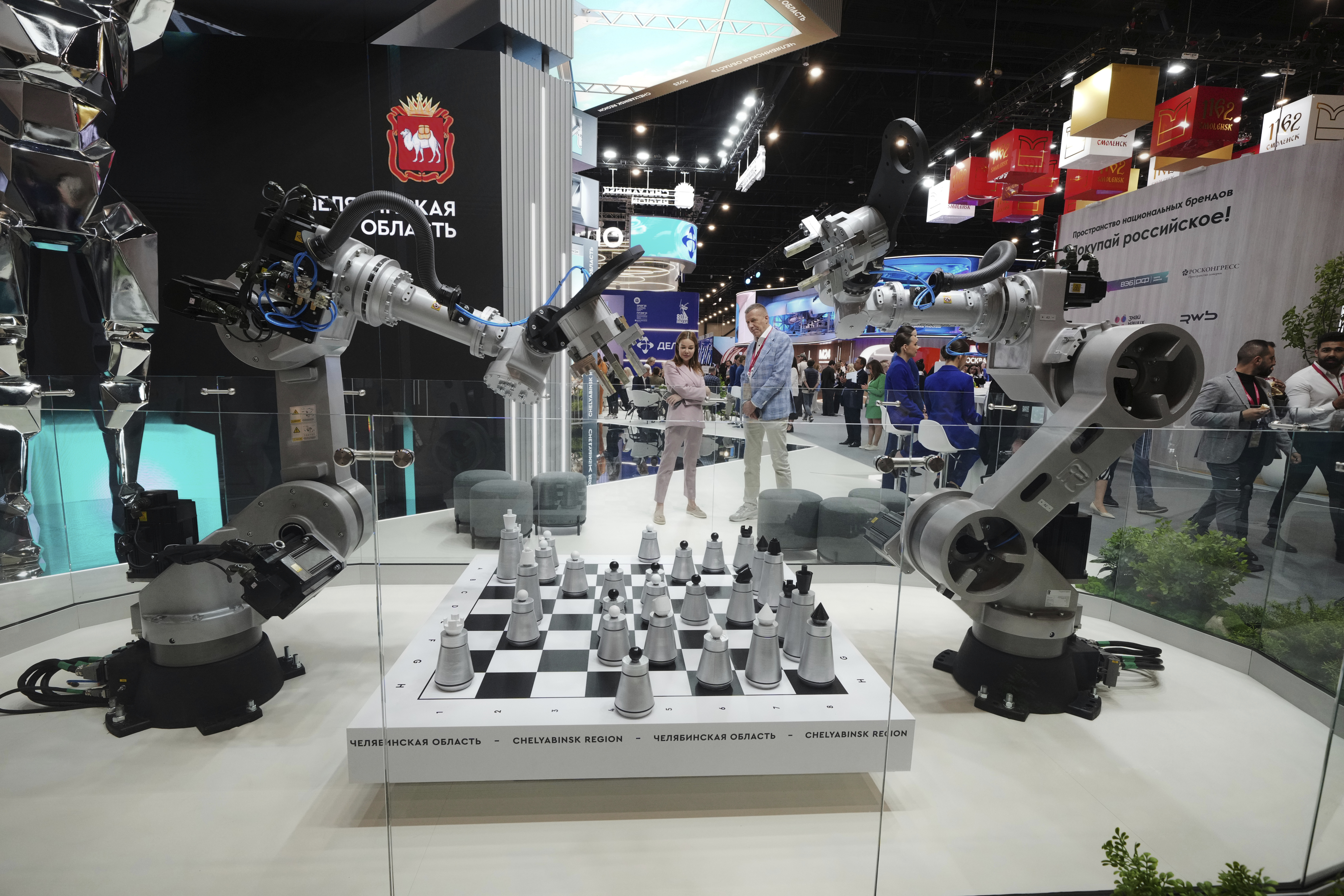 Visitors look at an exhibition on the sidelines of the St. Petersburg International Economic Forum in St. Petersburg, Russia, Wednesday, June 18, 2025. (AP Photo/Dmitri Lovetsky)