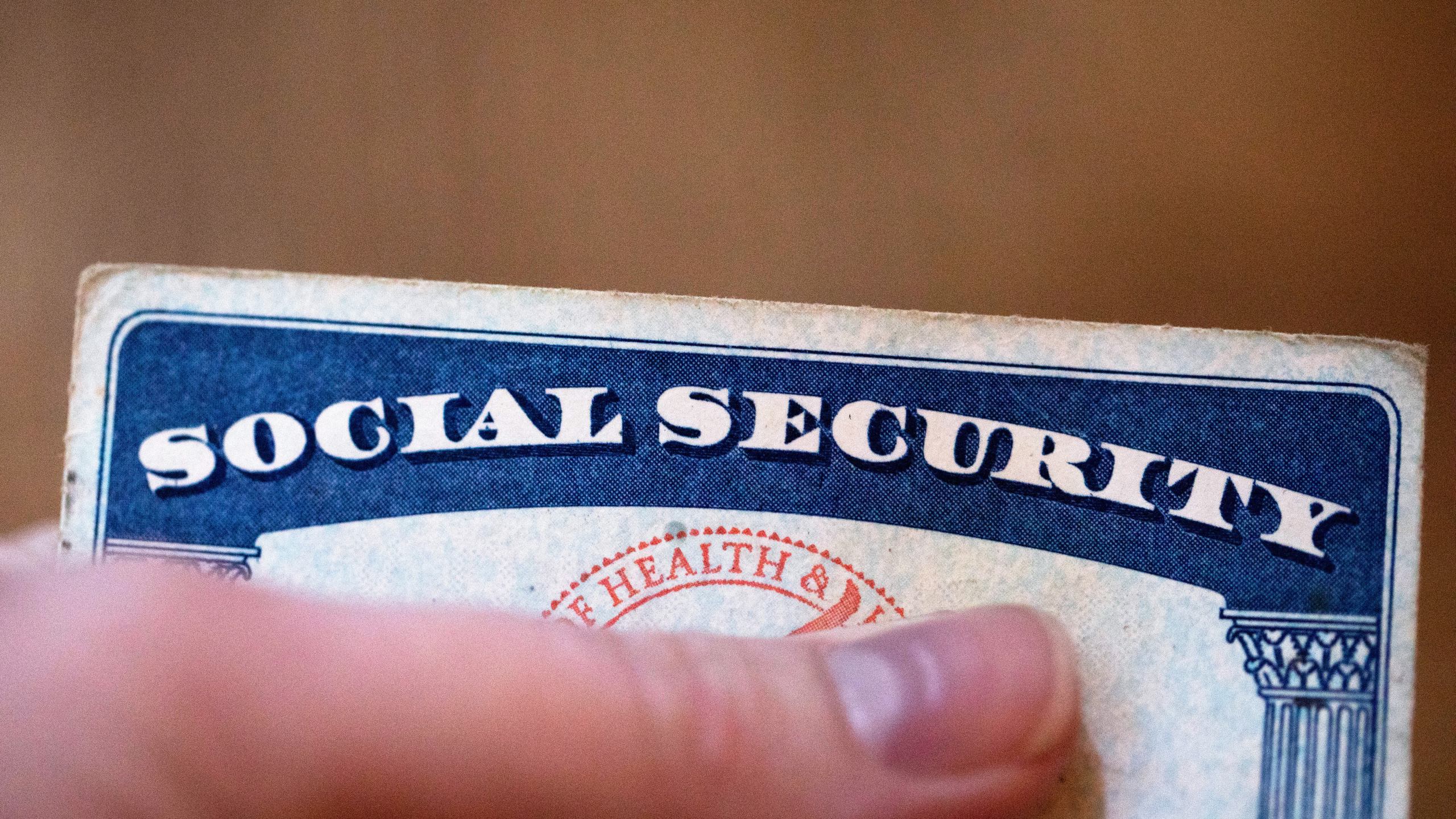 FILE - A Social Security card is displayed on Oct. 12, 2021, in Tigard, Ore. The go-broke dates for Medicare and Social Security’s trust funds have moved up as rising health care costs and new legislation affecting Social Security benefits have contributed to closer projected depletion dates. That's according to an annual report released Wednesday. (AP Photo/Jenny Kane, File)