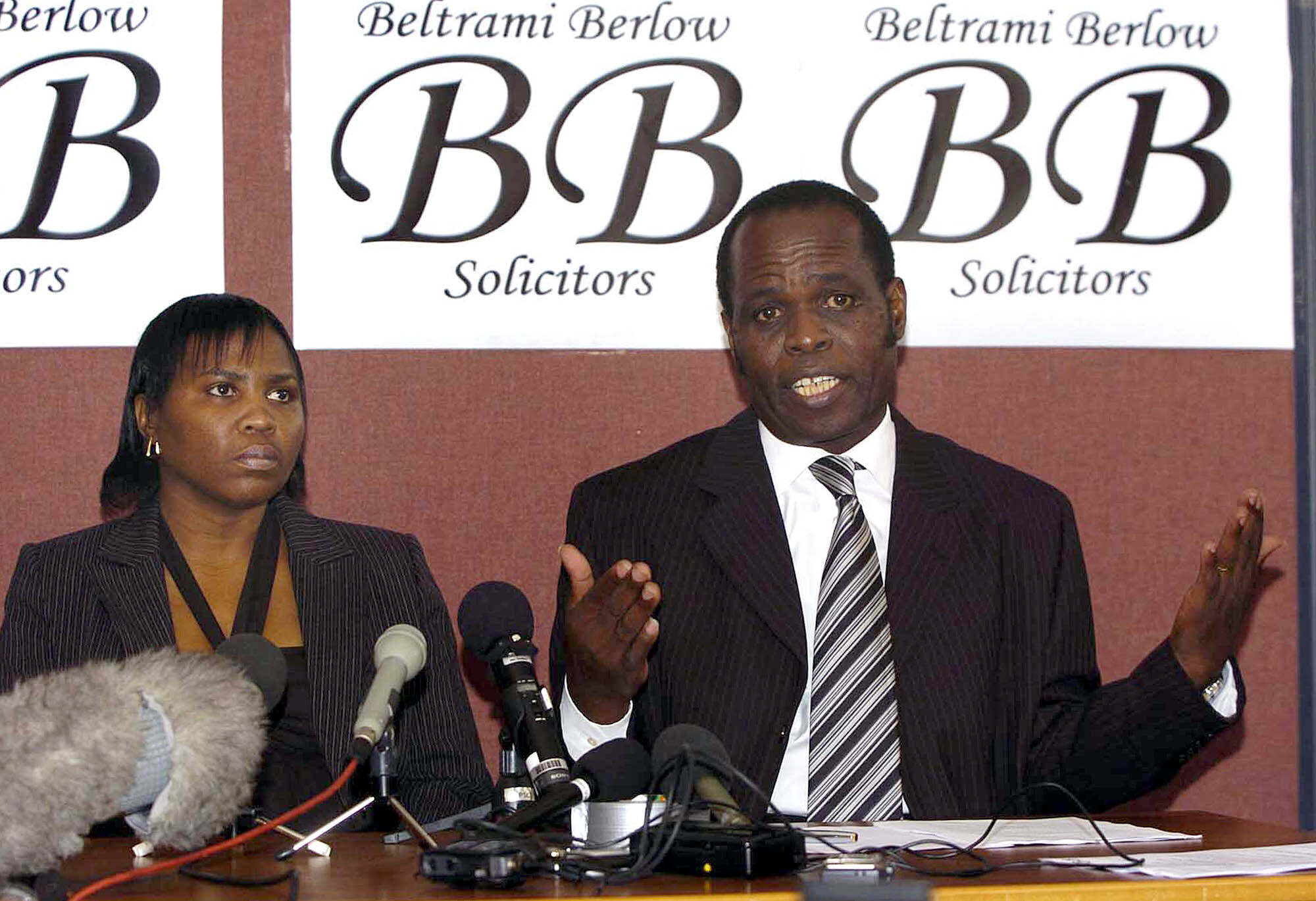 FILE - Self-styled Archbishop Gilbert Deya, right, speaks at a press conference in Glasgow, Scotland Wednesday Sept. 29, 2004 as he sits alongside pregnant woman Deonna Dakkins-Scott, who claims she became pregnant after she was blessed by Deya. (AP Photo/Ian Stewart, File)