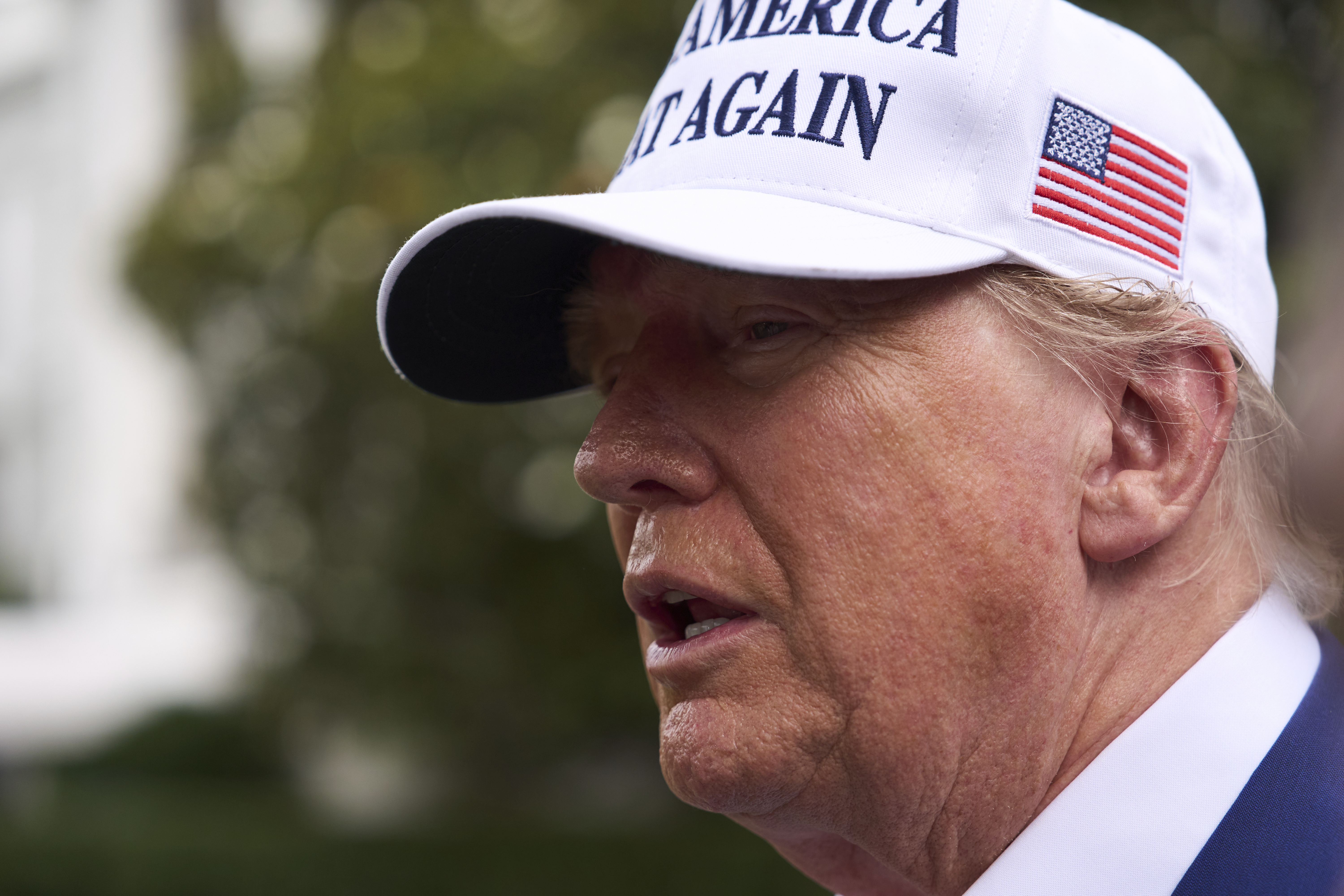 President Donald Trump speaks with reporters as a flag pole is installed on the South Lawn of the White House, Wednesday, June 18, 2025, in Washington. (AP Photo/Evan Vucci)