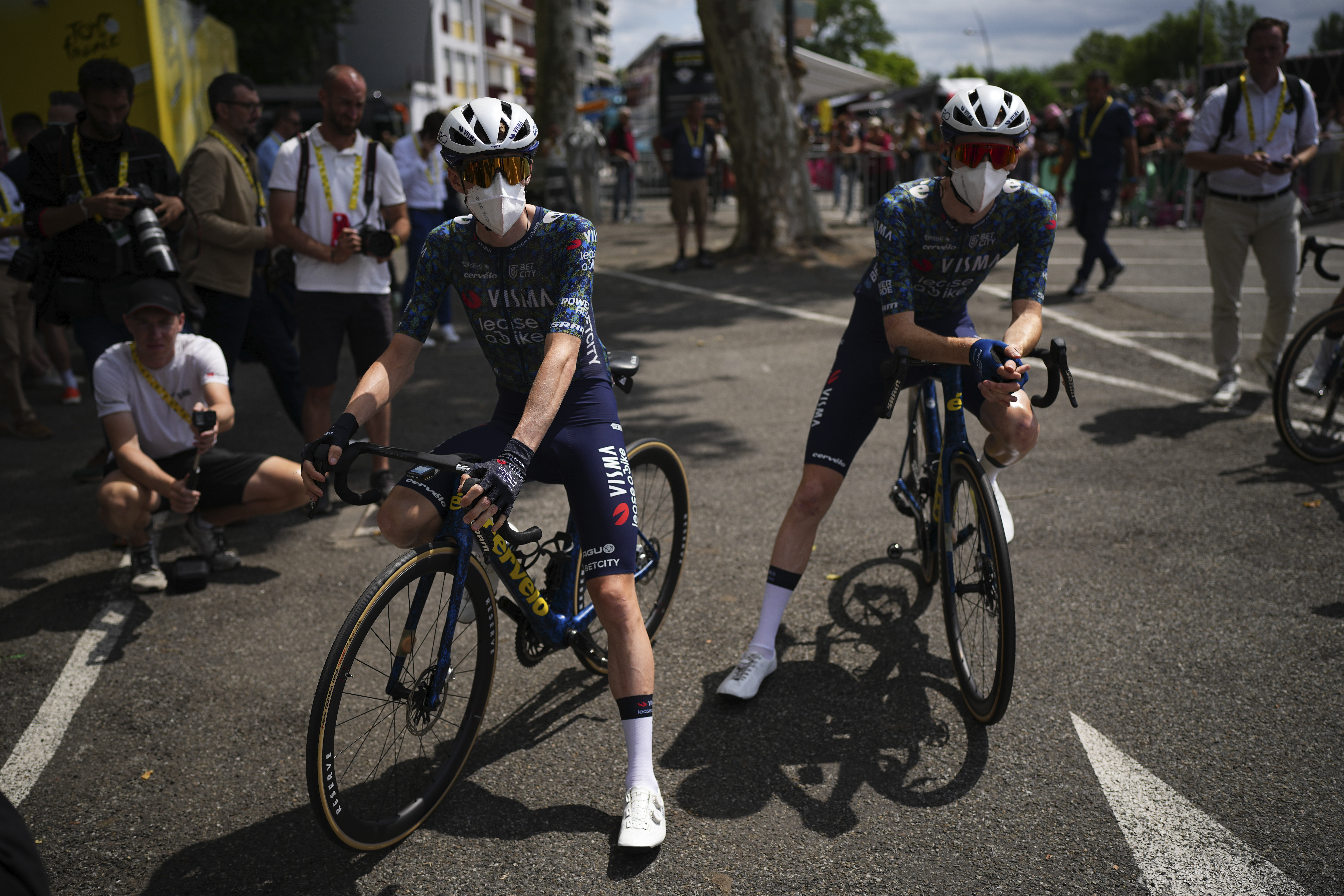 FILE - Denmark's Jonas Vingegaard, left, and teammate Matteo Jorgenson, of the U.S., wear face masks to protect themselves from the Corona virus prior to the start of the fourteenth stage of the Tour de France cycling race over 151.9 kilometers (94.4 miles) with start in Pau and finish in Saint-Lary-Soulan Pla d'Adet, France, July 13, 2024. (AP Photo/Daniel Cole, File)