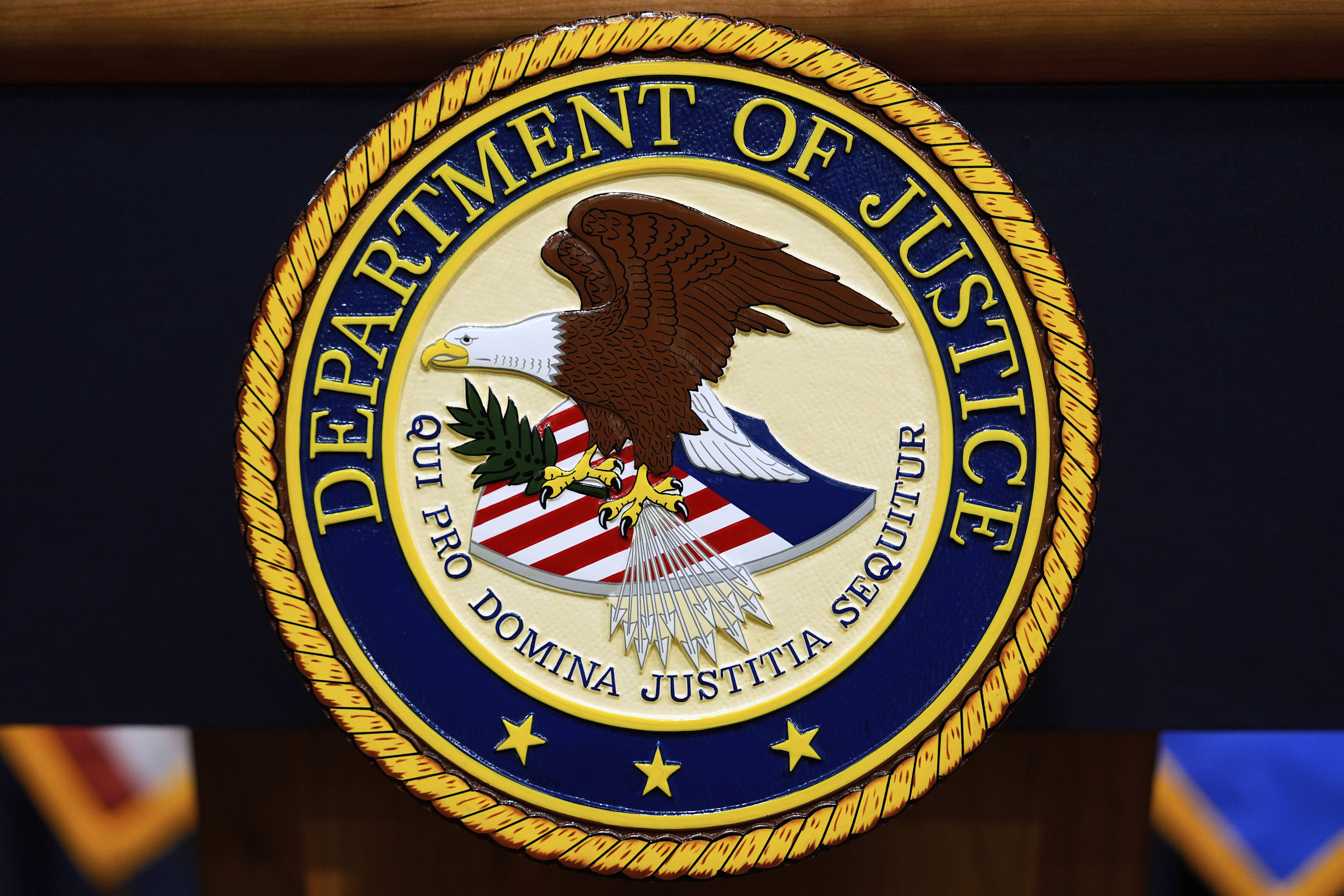 FILE - The U.S. Department of Justice logo is seen on a podium before a press conference with Attorney General Pam Bondi, Tuesday, May 6, 2025, at the Justice Department in Washington. (AP Photo/Julia Demaree Nikhinson, file)