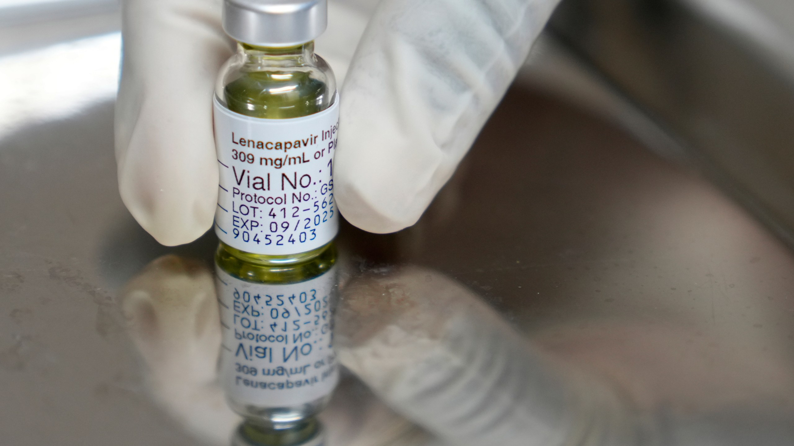 FILE - A pharmacist holds a vial of lenacapavir, an injectable HIV prevention drug, at the Desmond Tutu Health Foundation's Masiphumelele Research Site, in Cape Town, South Africa, Tuesday, July 23, 2024, which was one of the sites for Gilead's lenacapavir drug trial. (AP Photo/Nardus Engelbrecht, File)