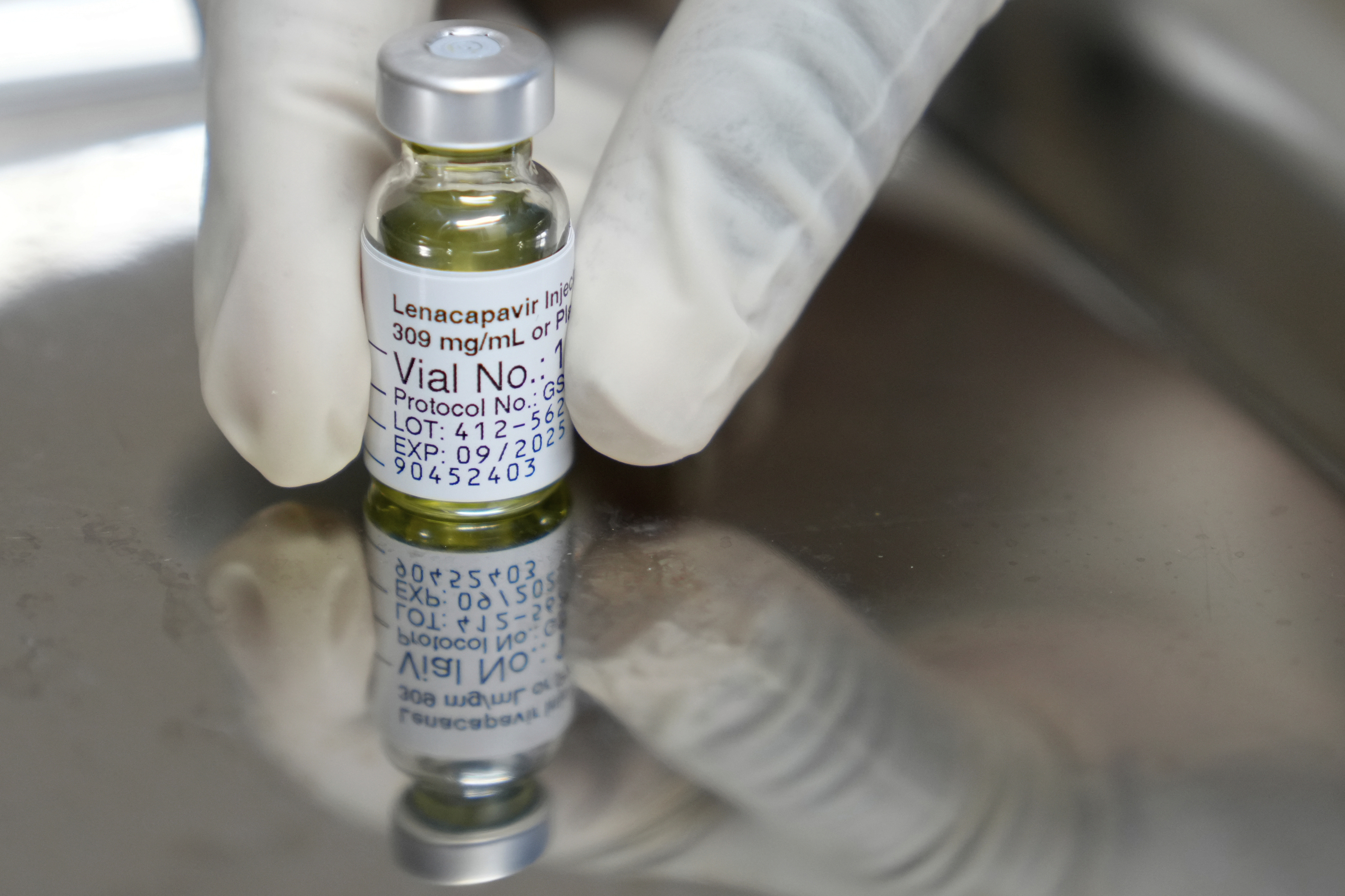FILE - A pharmacist holds a vial of lenacapavir, an injectable HIV prevention drug, at the Desmond Tutu Health Foundation's Masiphumelele Research Site, in Cape Town, South Africa, Tuesday, July 23, 2024, which was one of the sites for Gilead's lenacapavir drug trial. (AP Photo/Nardus Engelbrecht, File)