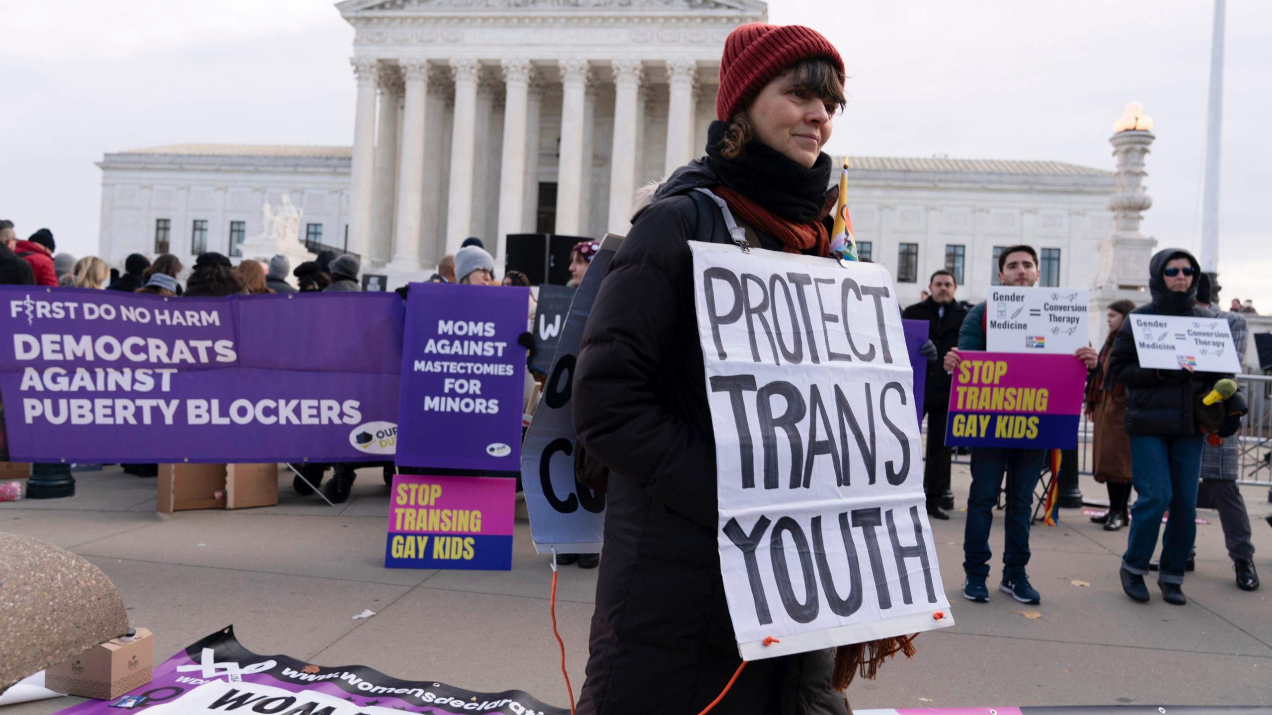 FILE - Protesters for and against gender-affirming care for transgender minors demonstrate outside the Supreme Court on Dec. 4, 2024, in Washington. (AP Photo/Jose Luis Magana, File)