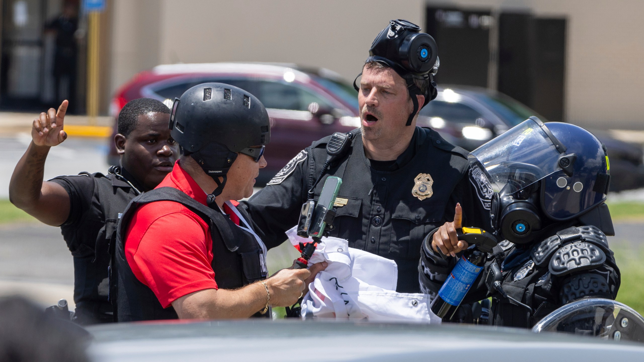 Police tell Spanish-language reporter Mario Guevara to move back during a protest on ICE raids and deportation arrests on Chamblee Tucker Road in Atlanta on Saturday, June 14, 2025. (Arvin Temkar/Atlanta Journal-Constitution via AP)