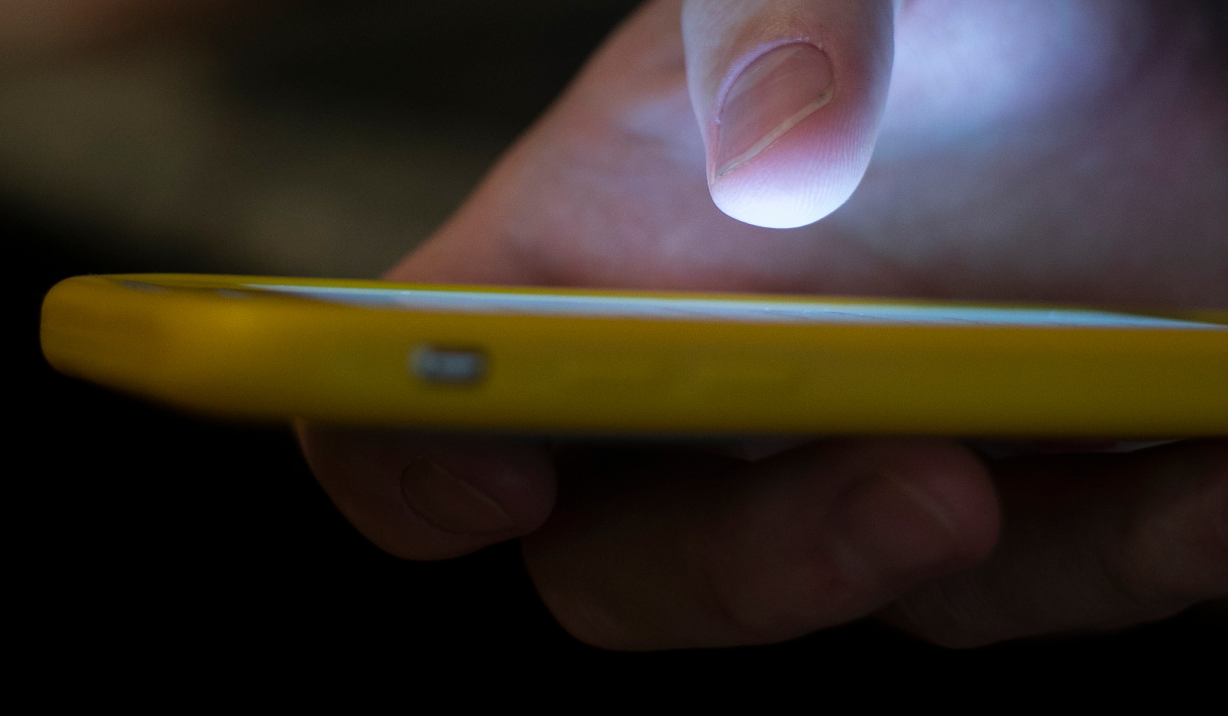 FILE - A man uses a cell phone in New Orleans, Aug. 11, 2019. (AP Photo/Jenny Kane, File)