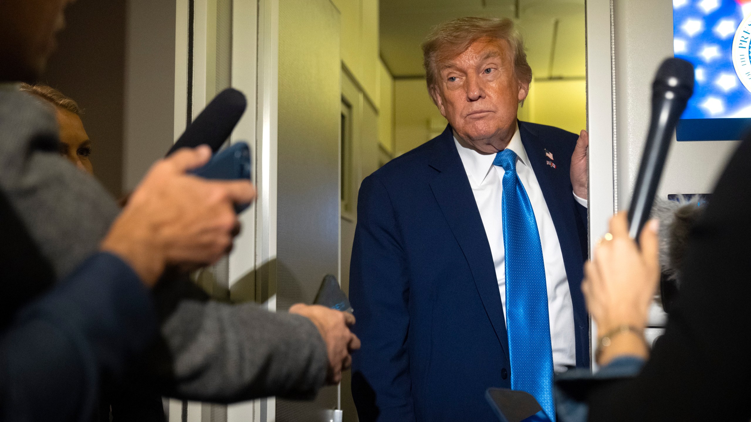 President Donald Trump speaks with reporters while flying aboard Air Force One en route from Calgary, Canada to Joint Base Andrews, Md., late Monday, June 16, 2025. (AP Photo/Mark Schiefelbein)