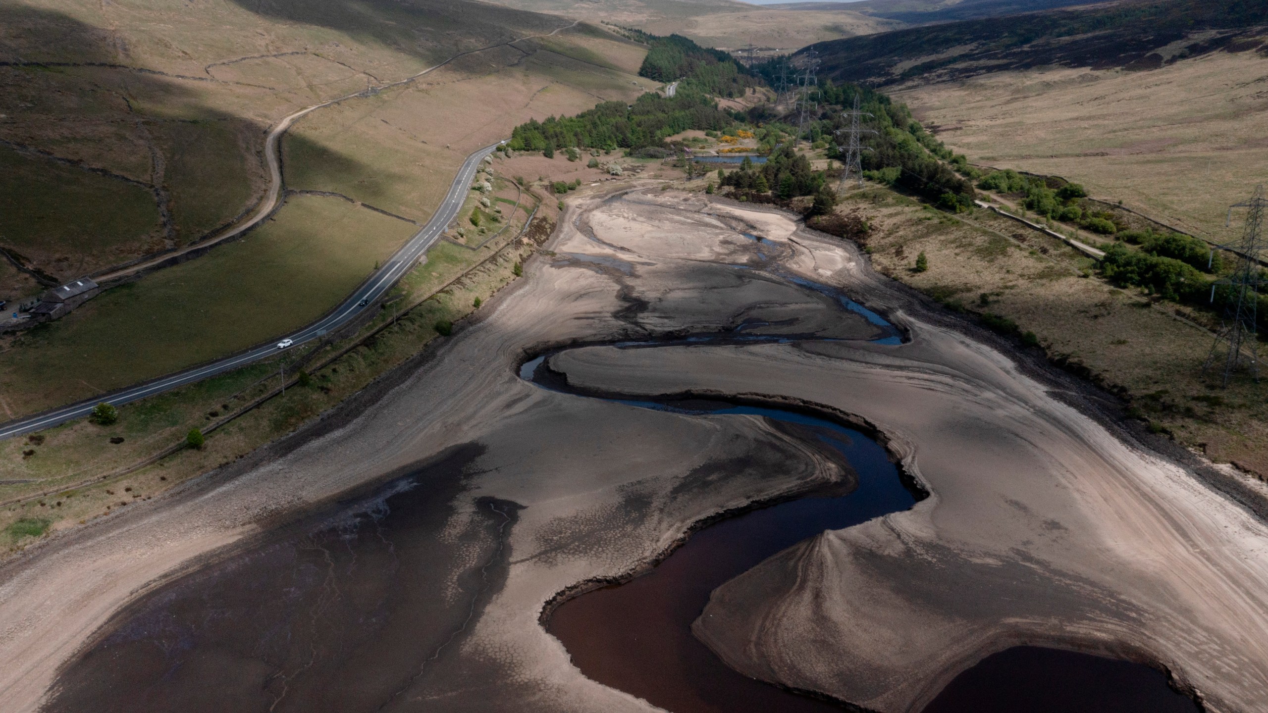 FILE - Low water levels are visible at Woodhead Reservoir in Derbyshire as the area experiences a significant drought, in Woodhead, England, Monday, May 19, 2025. (AP Photo/Jon Super, File)