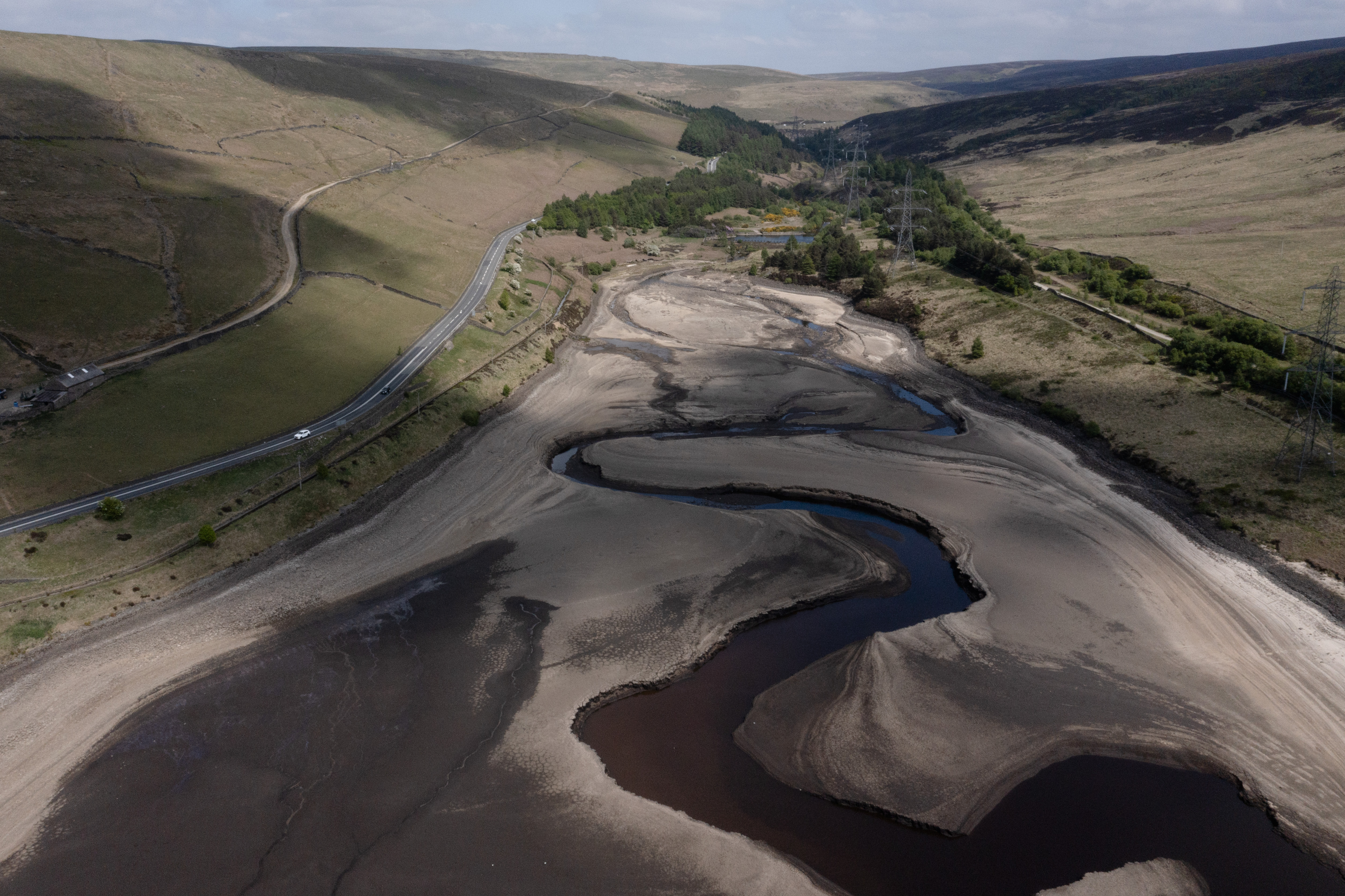 FILE - Low water levels are visible at Woodhead Reservoir in Derbyshire as the area experiences a significant drought, in Woodhead, England, Monday, May 19, 2025. (AP Photo/Jon Super, File)