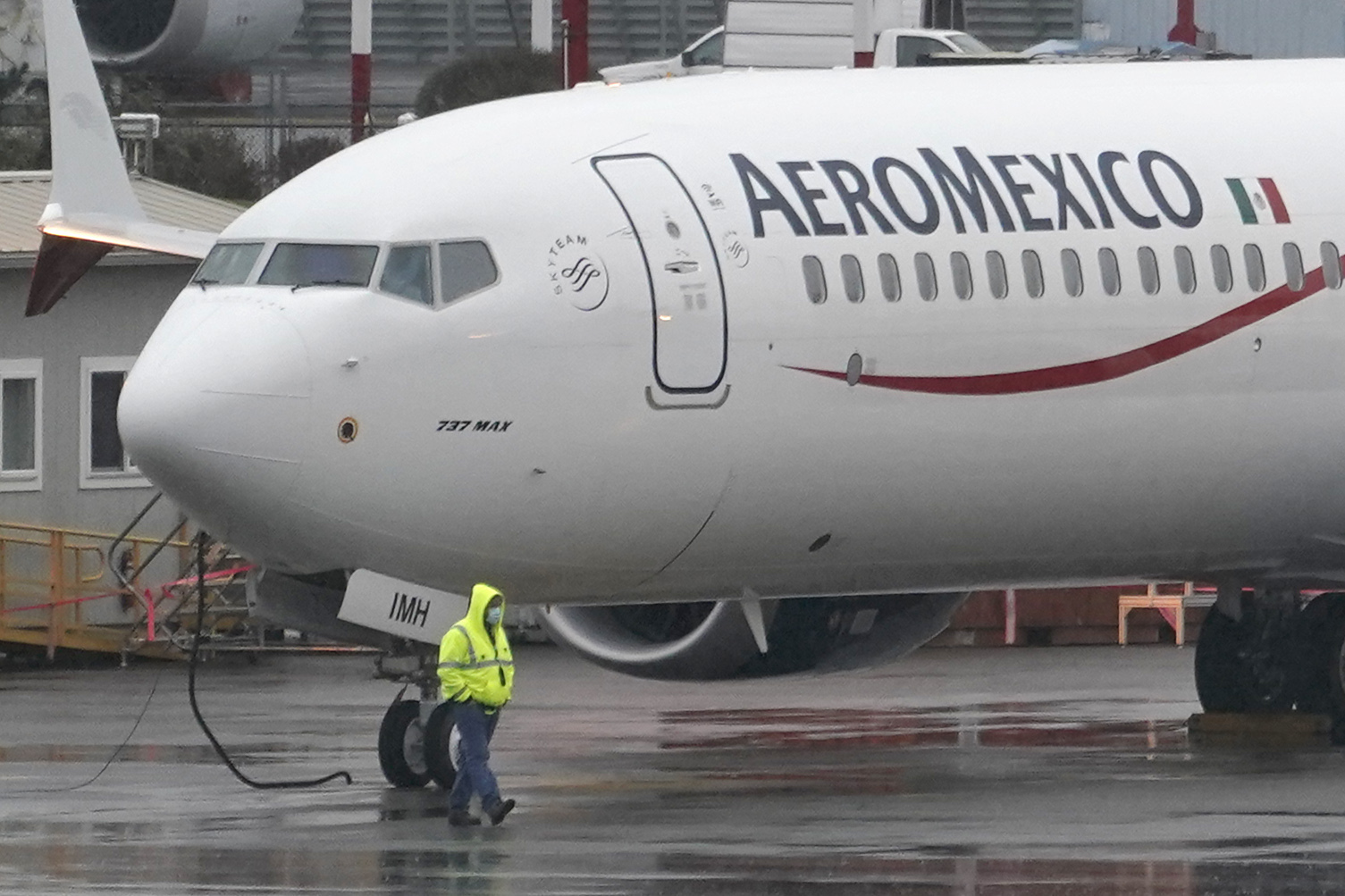 FILE - A worker wearing a mask walks past a Boeing 737 Max 9 as it is prepared for a flight from Renton Municipal Airport, Nov. 18, 2020, in Renton, Wash. (AP Photo/Ted S. Warren, File)