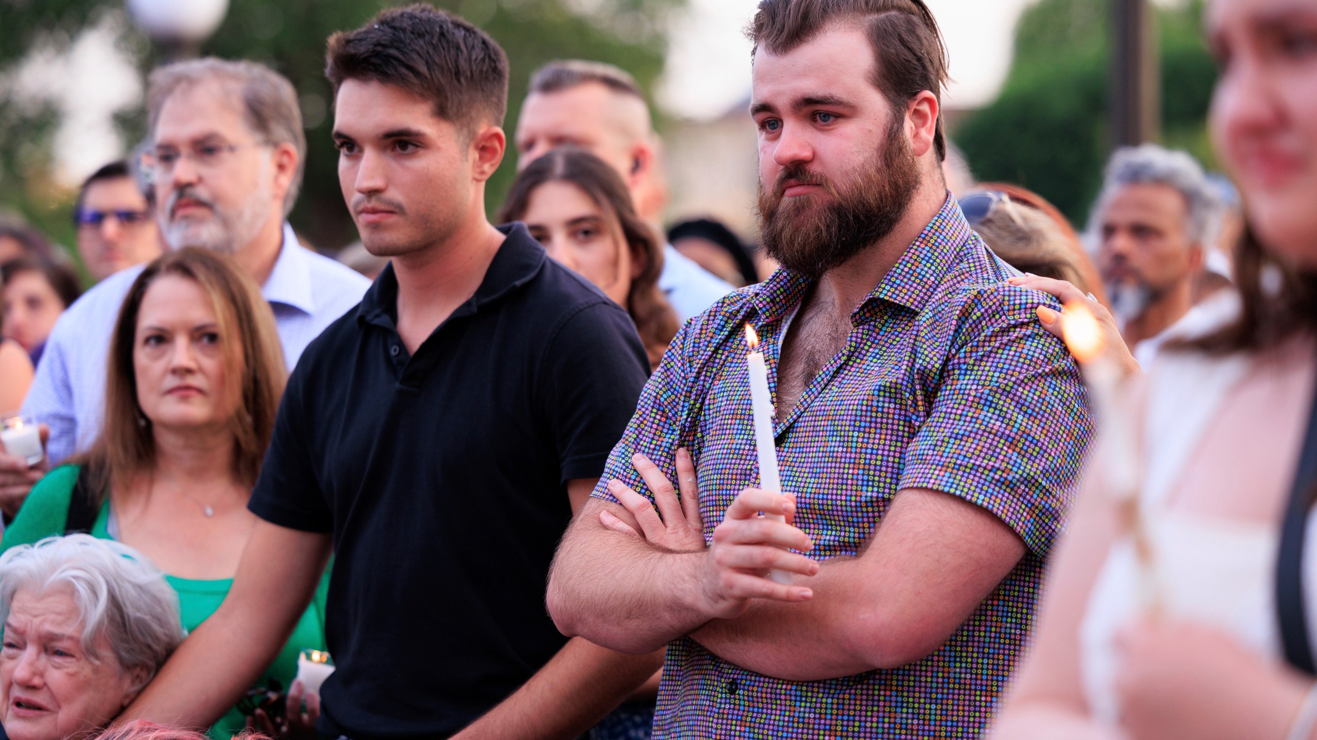 Colin Hortman, right, attends a candlelight vigil for his parents, former House Speaker Melissa Hortman and her husband Mark, who were fatally shot, at the state Capitol, Wednesday, June 18, 2025, in St. Paul, Minn. (AP Photo/Nikolas Liepins)