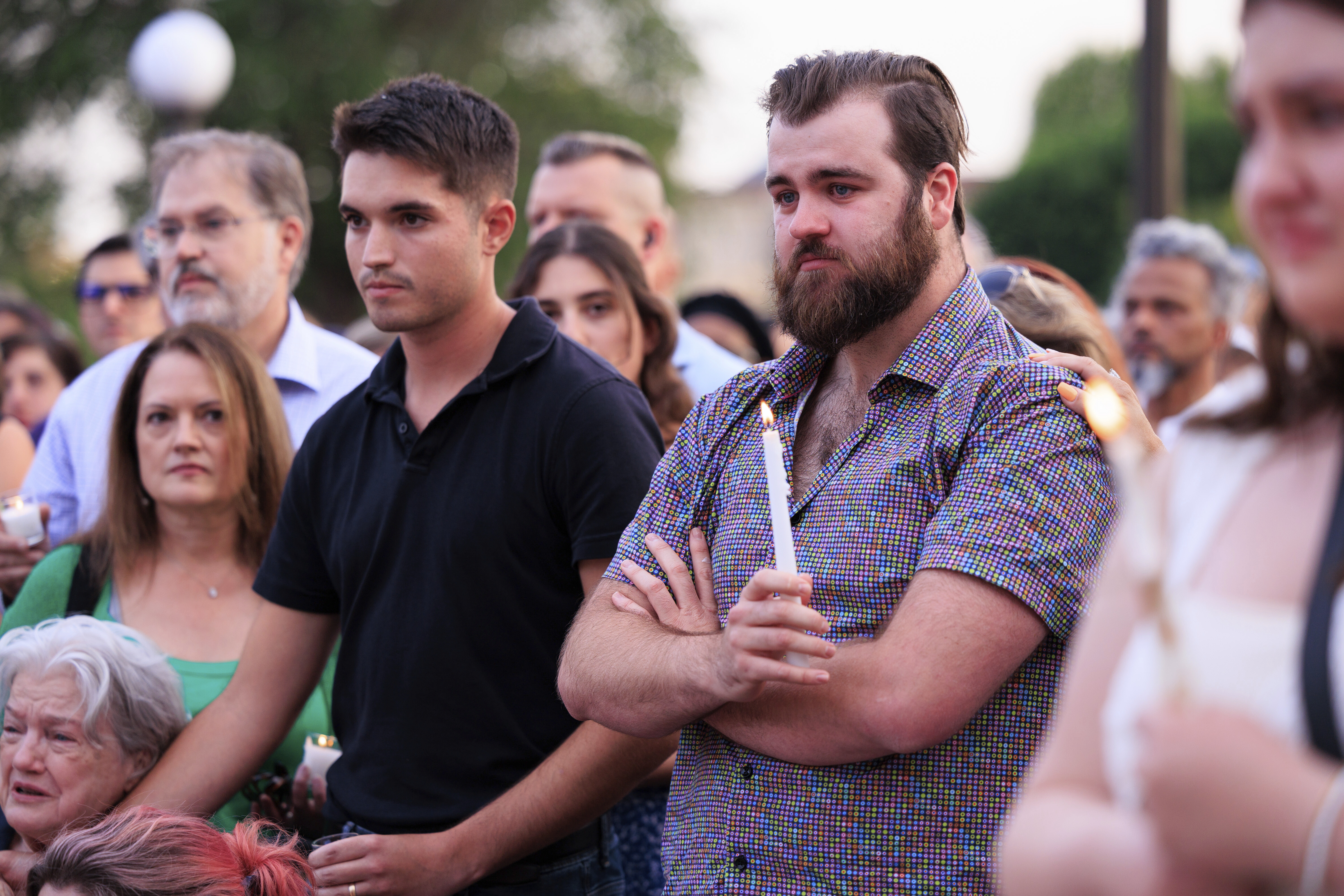 Colin Hortman, right, attends a candlelight vigil for his parents, former House Speaker Melissa Hortman and her husband Mark, who were fatally shot, at the state Capitol, Wednesday, June 18, 2025, in St. Paul, Minn. (AP Photo/Nikolas Liepins)