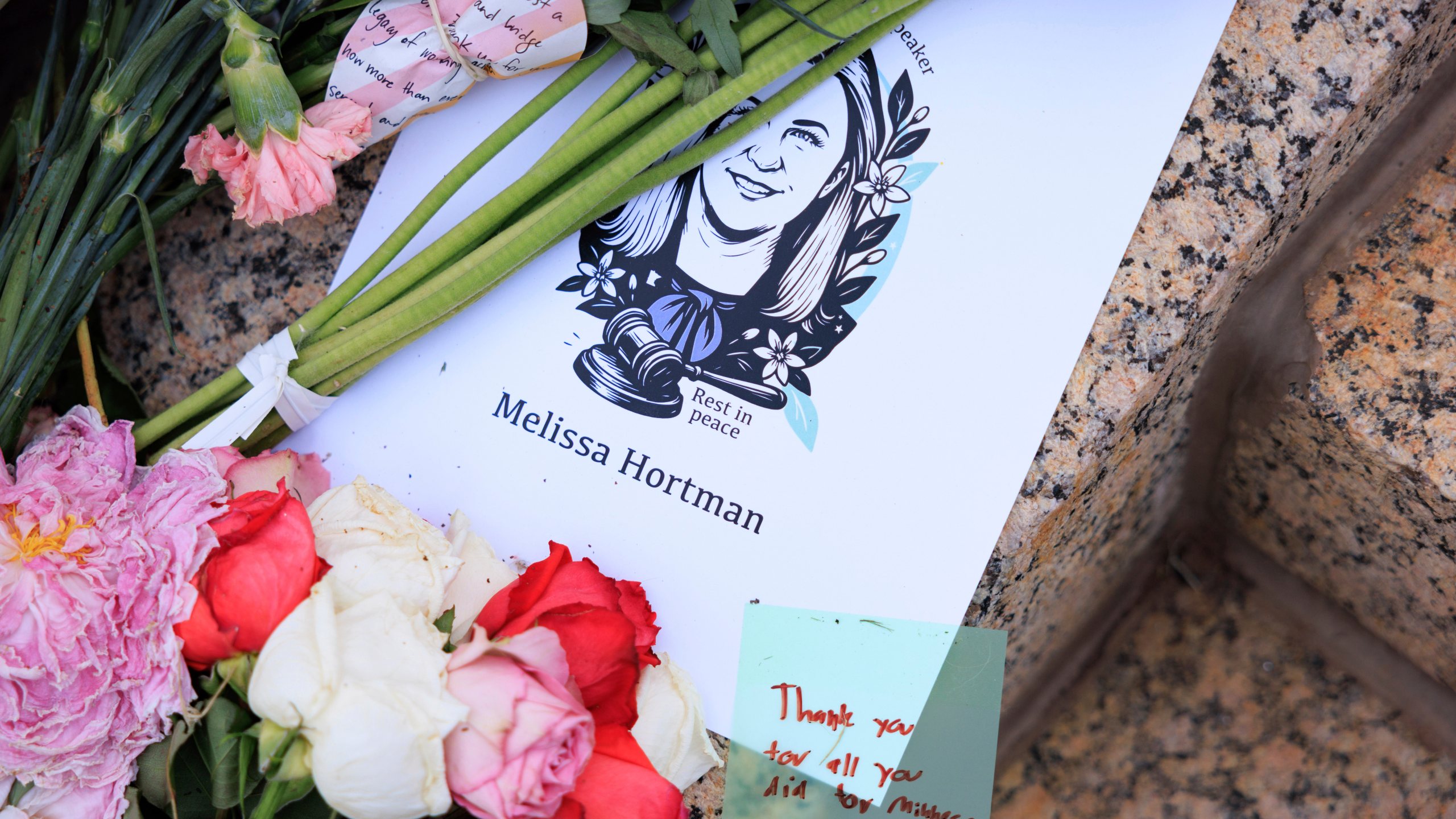 People attend a candlelight vigil for former House Speaker Melissa Hortman and her husband Mark, who were fatally shot, at the state Capitol, Wednesday, June 18, 2025, in St. Paul, Minn. (AP Photo/Nikolas Liepins)