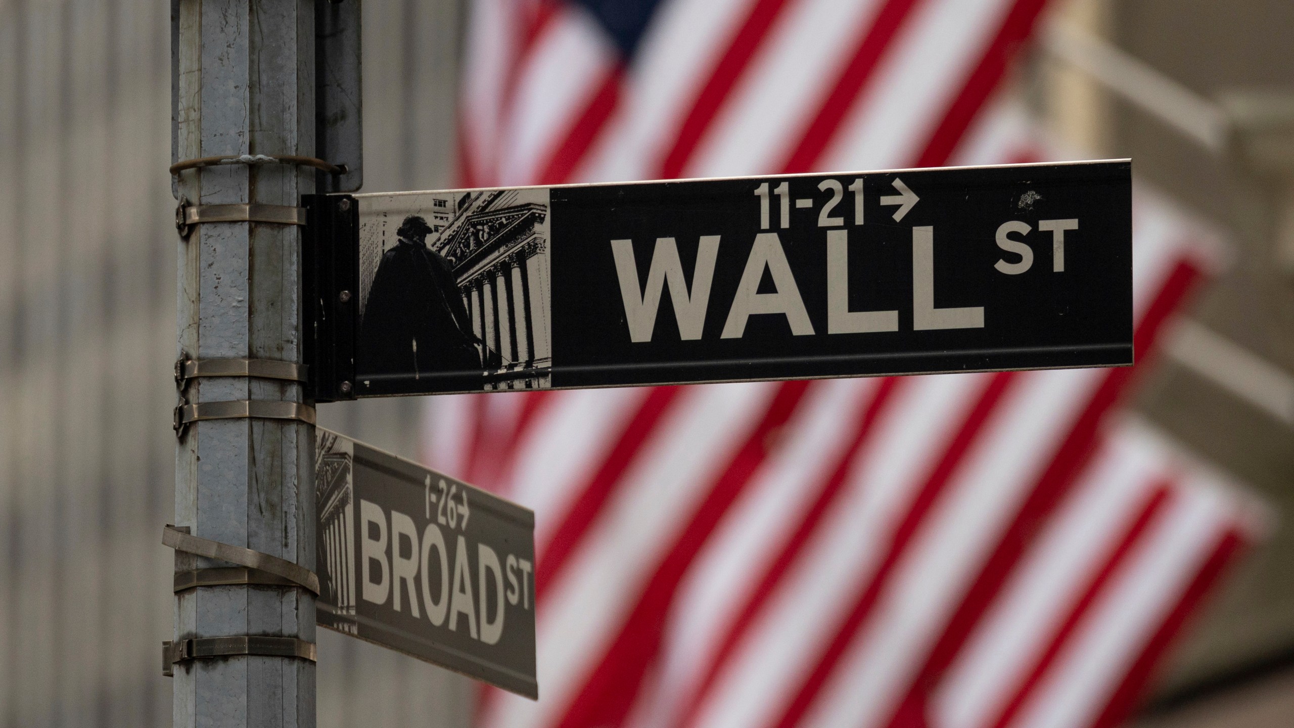 A Wall Street sign hangs near to the New York Stock Exchange, Wednesday, June 18, 2025, in New York. (AP Photo/Yuki Iwamura)