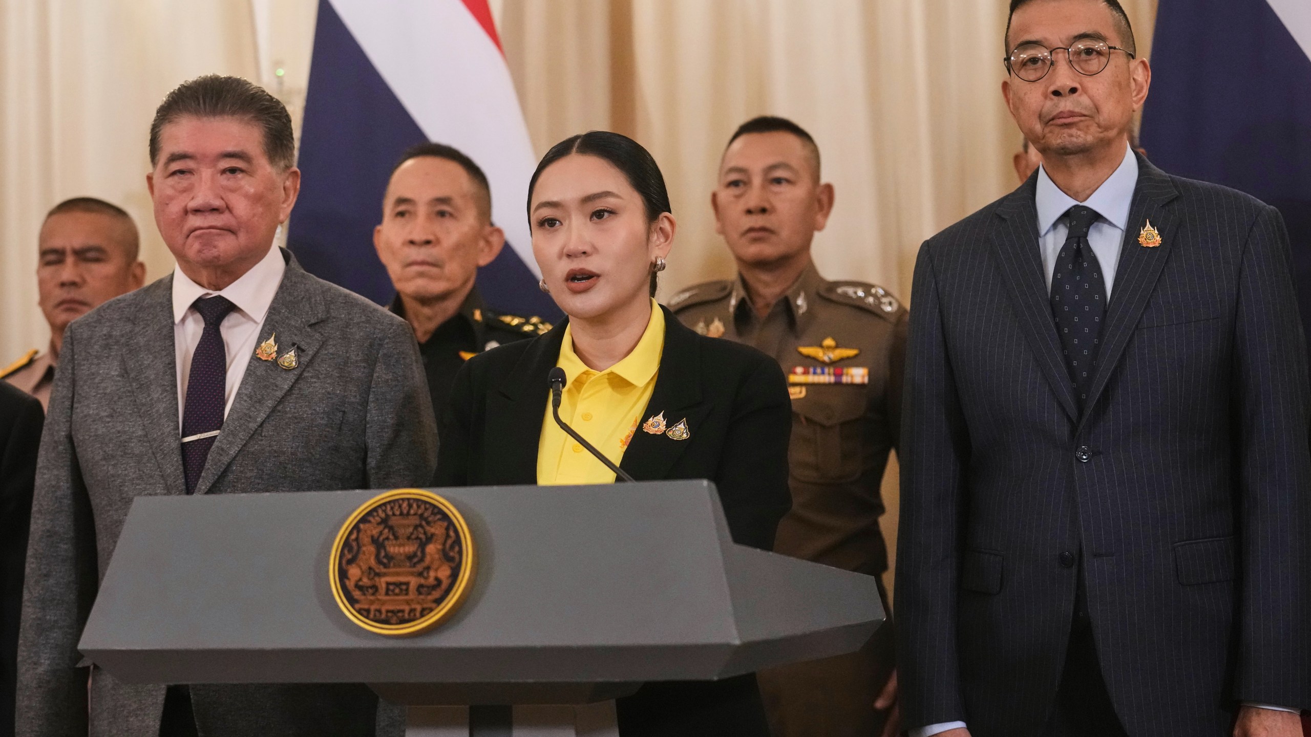 Thailand's Prime Minister Paetongtarn Shinawatra, center, talks to reporters at Government house in Bangkok, Thailand, Thursday, June 19, 2025. (AP Photo/Sakchai Lalit)