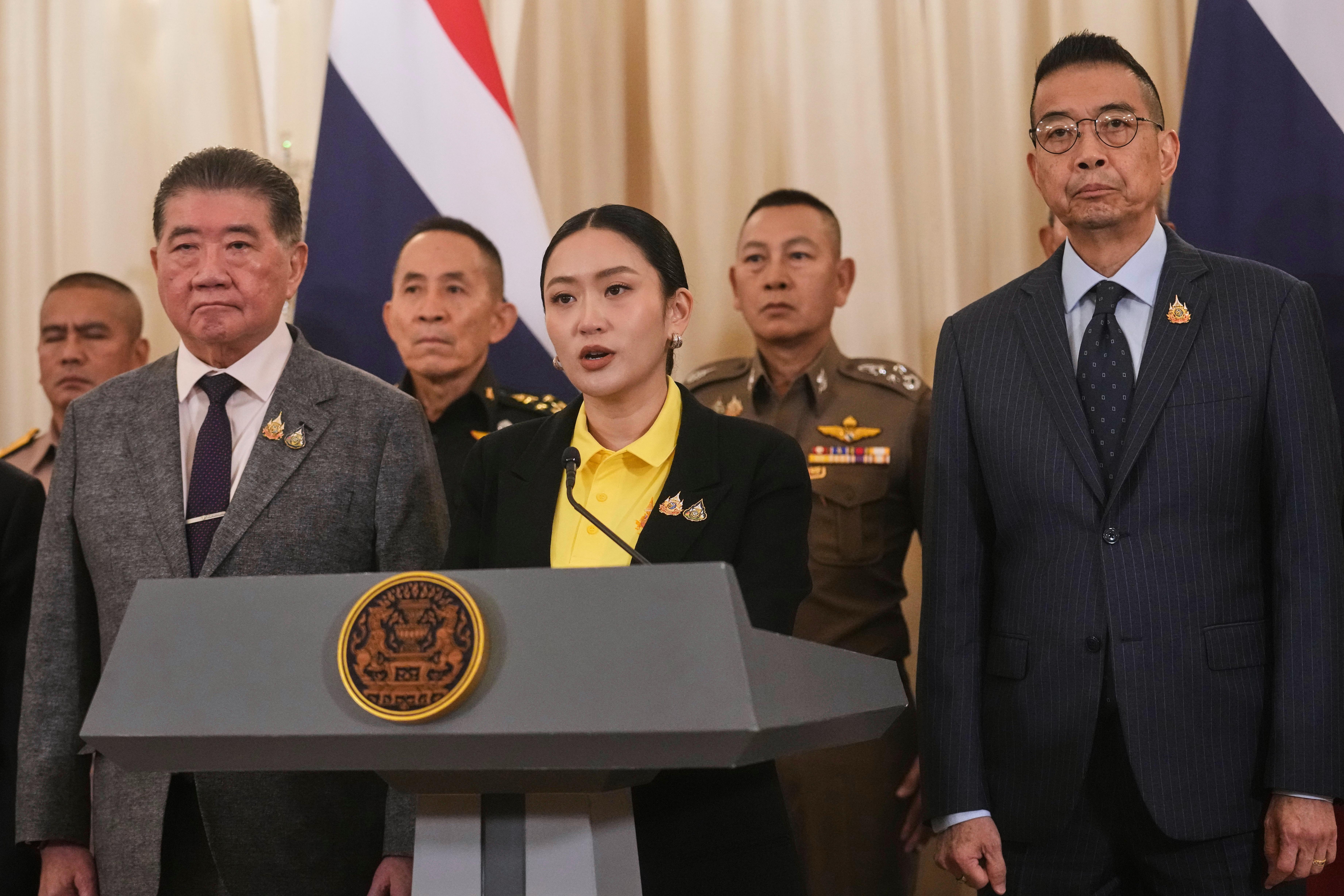 Thailand's Prime Minister Paetongtarn Shinawatra, center, talks to reporters at Government house in Bangkok, Thailand, Thursday, June 19, 2025. (AP Photo/Sakchai Lalit)