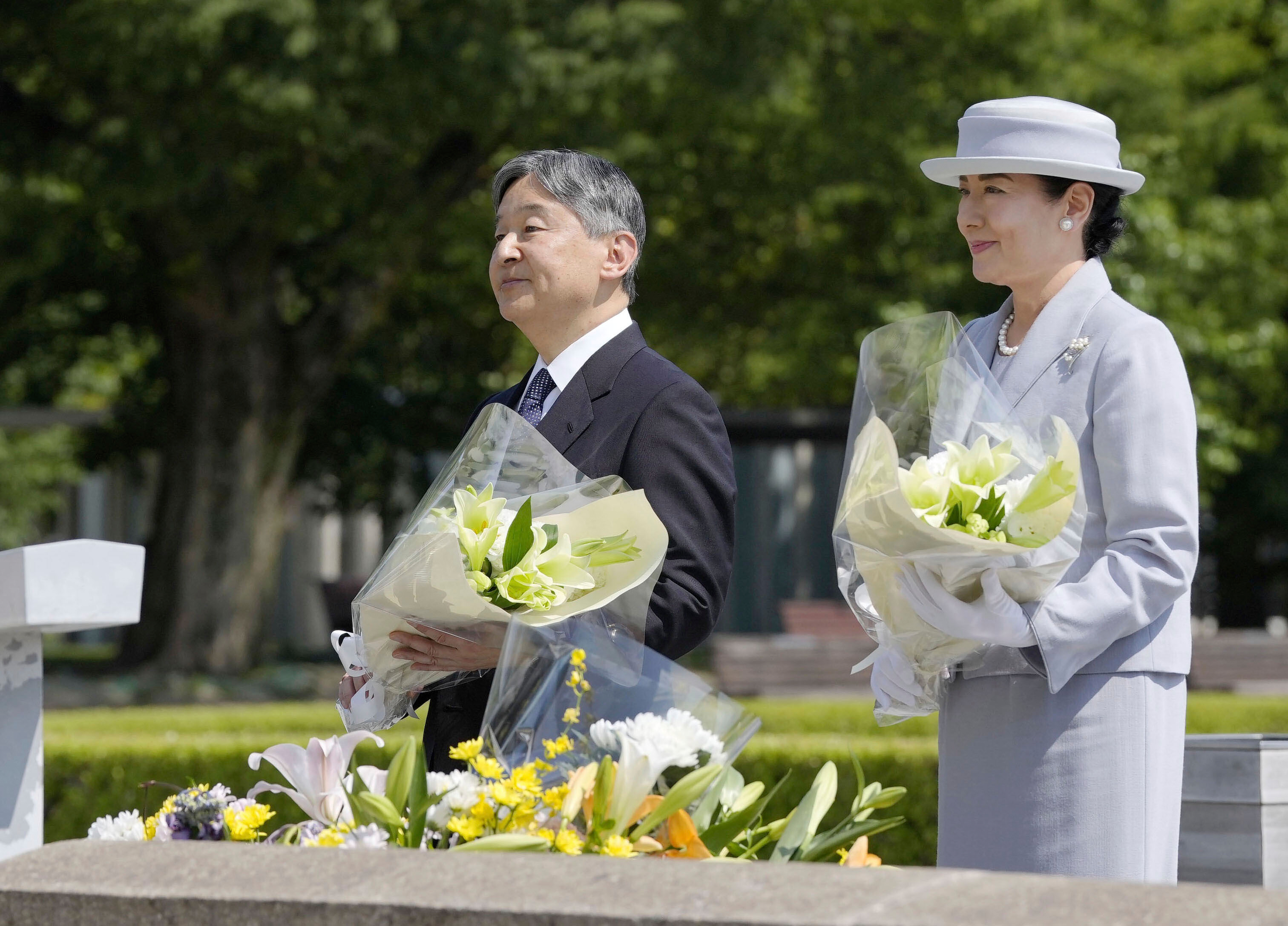Japanese Emperor Naruhito and Empress Masako offer flowers at the cenotaph dedicated to the victims of the atomic bombing as they visit the Peace Memorial Park in Hiroshima, western Japan Thursday, June 19, 2025. (Kai Naito/Kyodo News via AP)