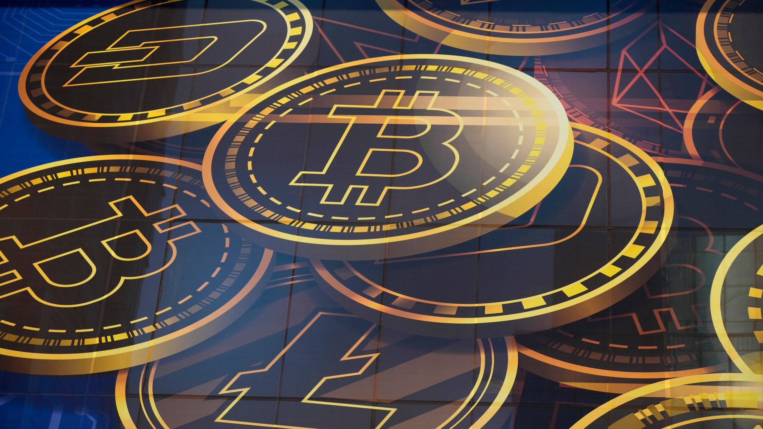FILE - An advertisement for the cryptocurrency, Bitcoin, is displayed on a building in Hong Kong on Nov. 18, 2021. (AP Photo/Kin Cheung, File)