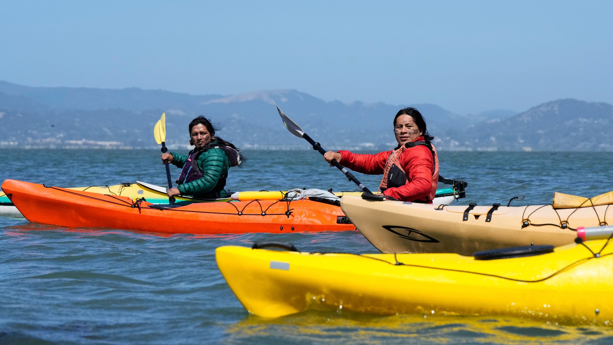 From left, Juan Bay, president of the Waorani people of Ecuador, and Nadino Calapucha, a spokesperson for the Kichwa Pakkiru people, kayak in the San Francisco Bay, Thursday, June 19, 2025, in Richmond, Calif. (AP Photo/Godofredo A. Vásquez)