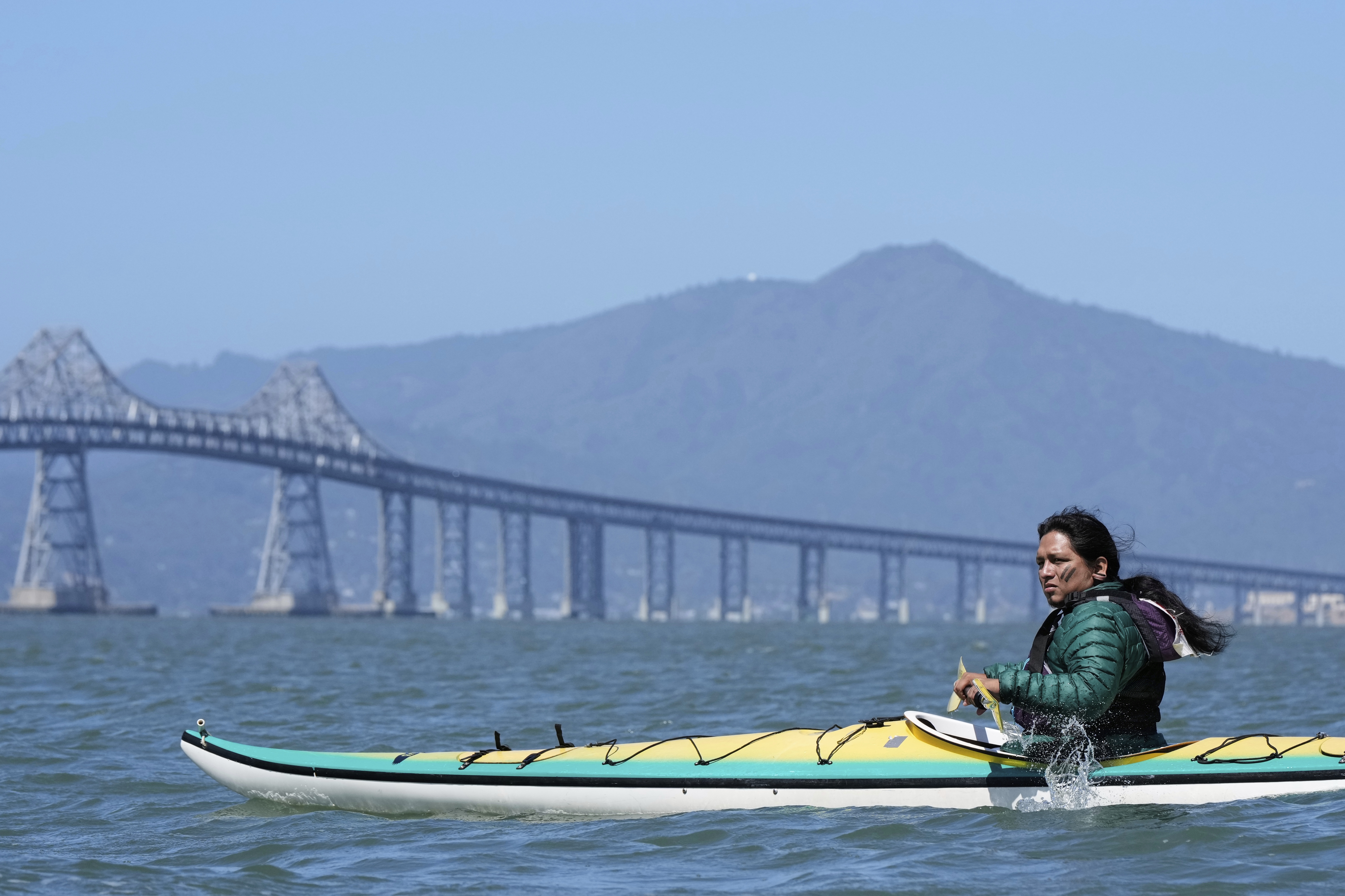 Juan Bay, president of the Waorani people of Ecuador, kayaks in the San Francisco Bay toward the Chevron Long Wharf, Thursday, June 19, 2025, in Richmond, Calif. (AP Photo/Godofredo A. Vásquez)
