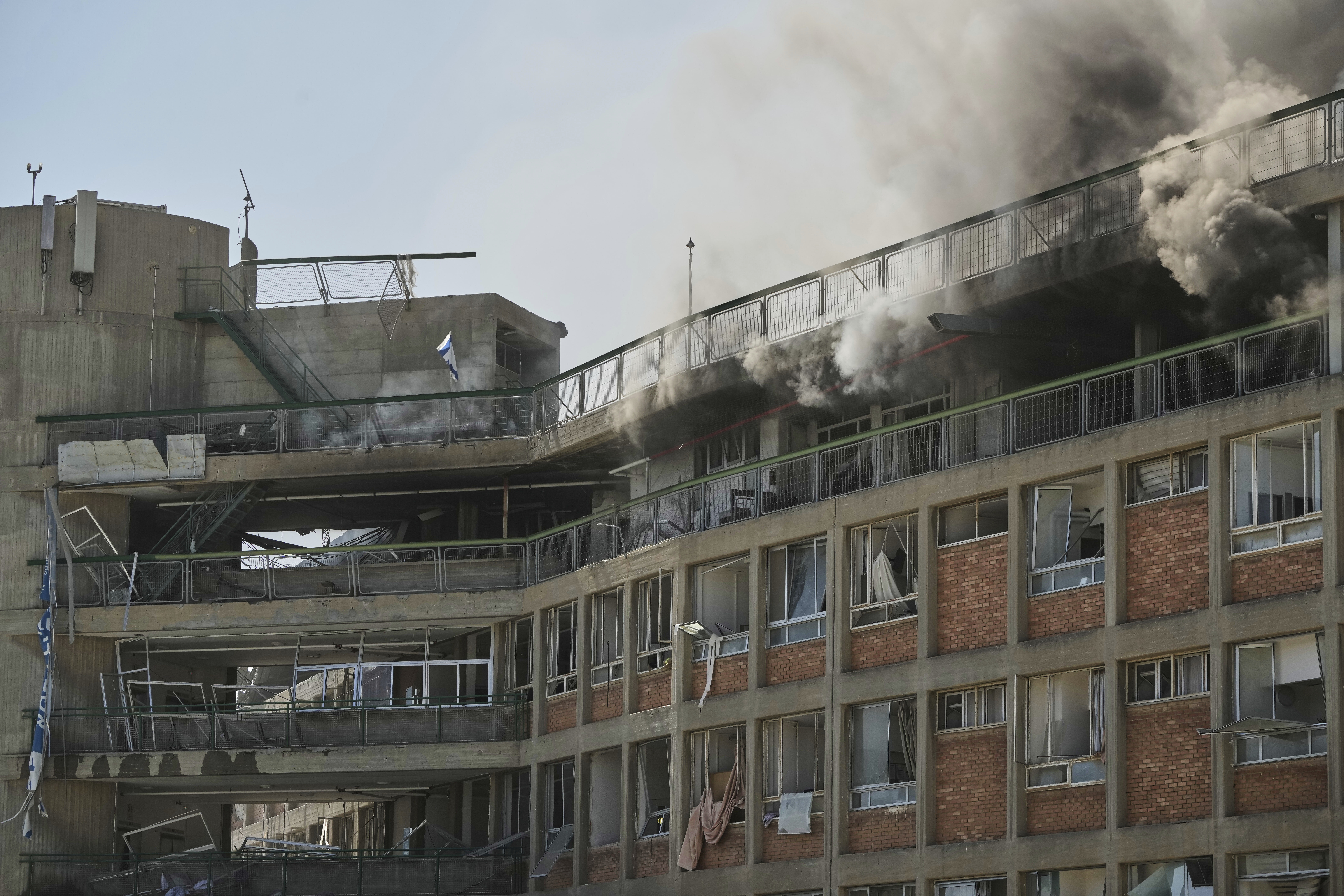 Smokes rises from a building of the Soroka hospital complex after it was hit by a missile fired from Iran in Beersheba, Israel, Thursday, June 19, 2025. (AP Photo/Leo Correa)