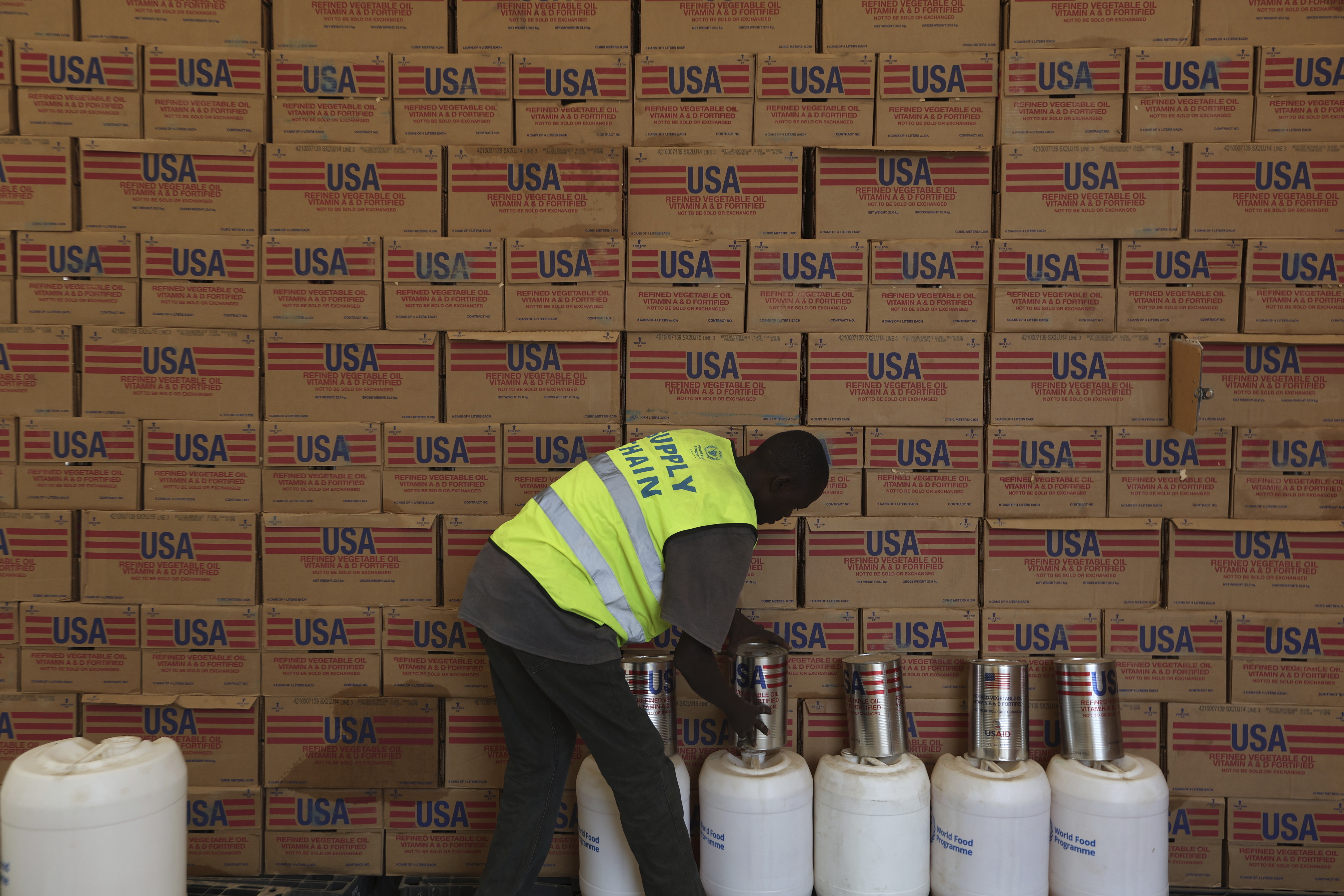 A man arranges USAID humanitarian aid inside a warehouse run by the World Food Programme (WFP) at Kakuma Refugee Camp in Turkana, Kenya Tuesday, June 3, 2025. (AP Photo/Andrew)