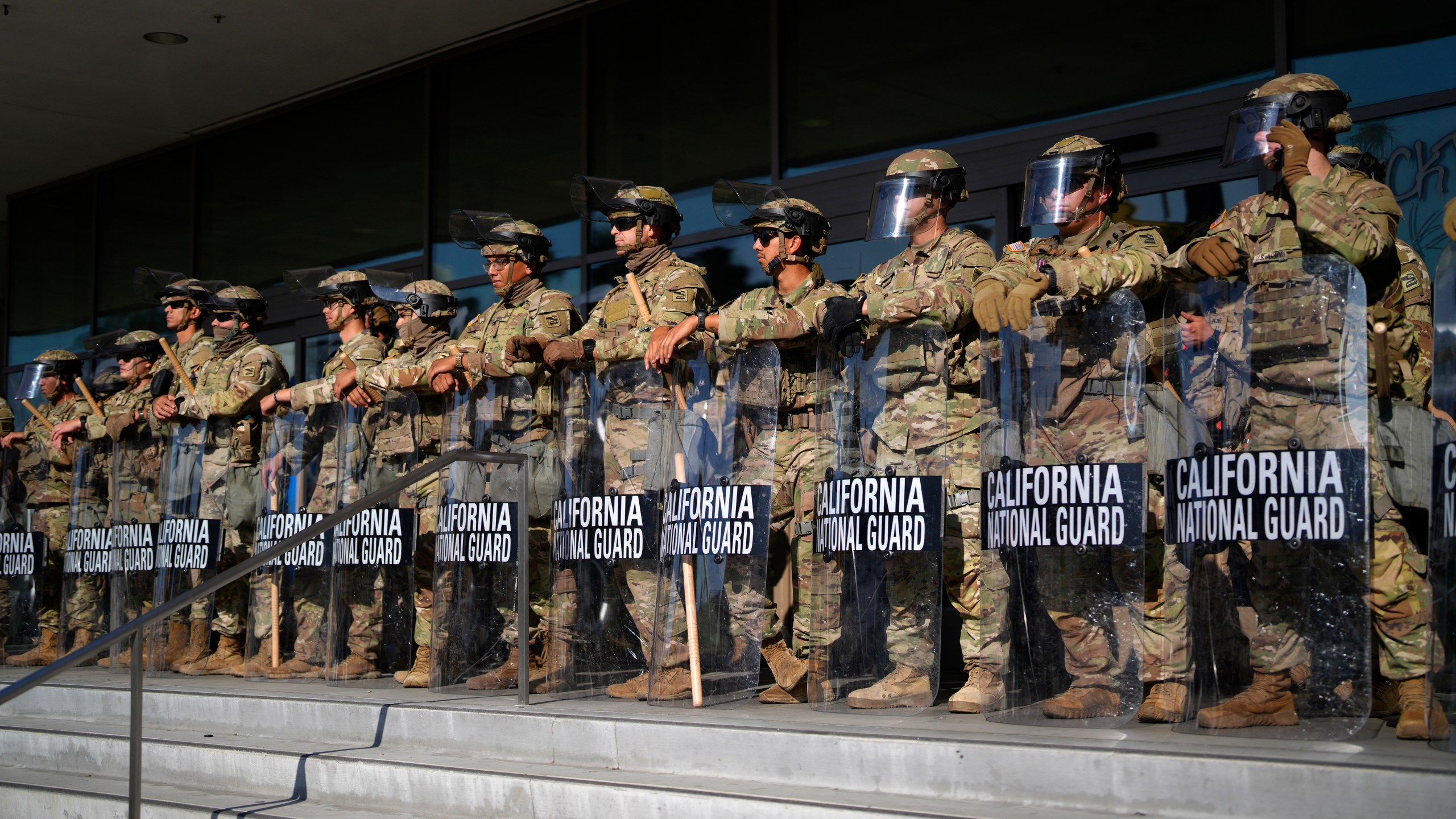 California National Guard stand in formation guarding the federal building in downtown Los Angeles on Tuesday, June 10, 2025. (AP Photo/Eric Thayer)