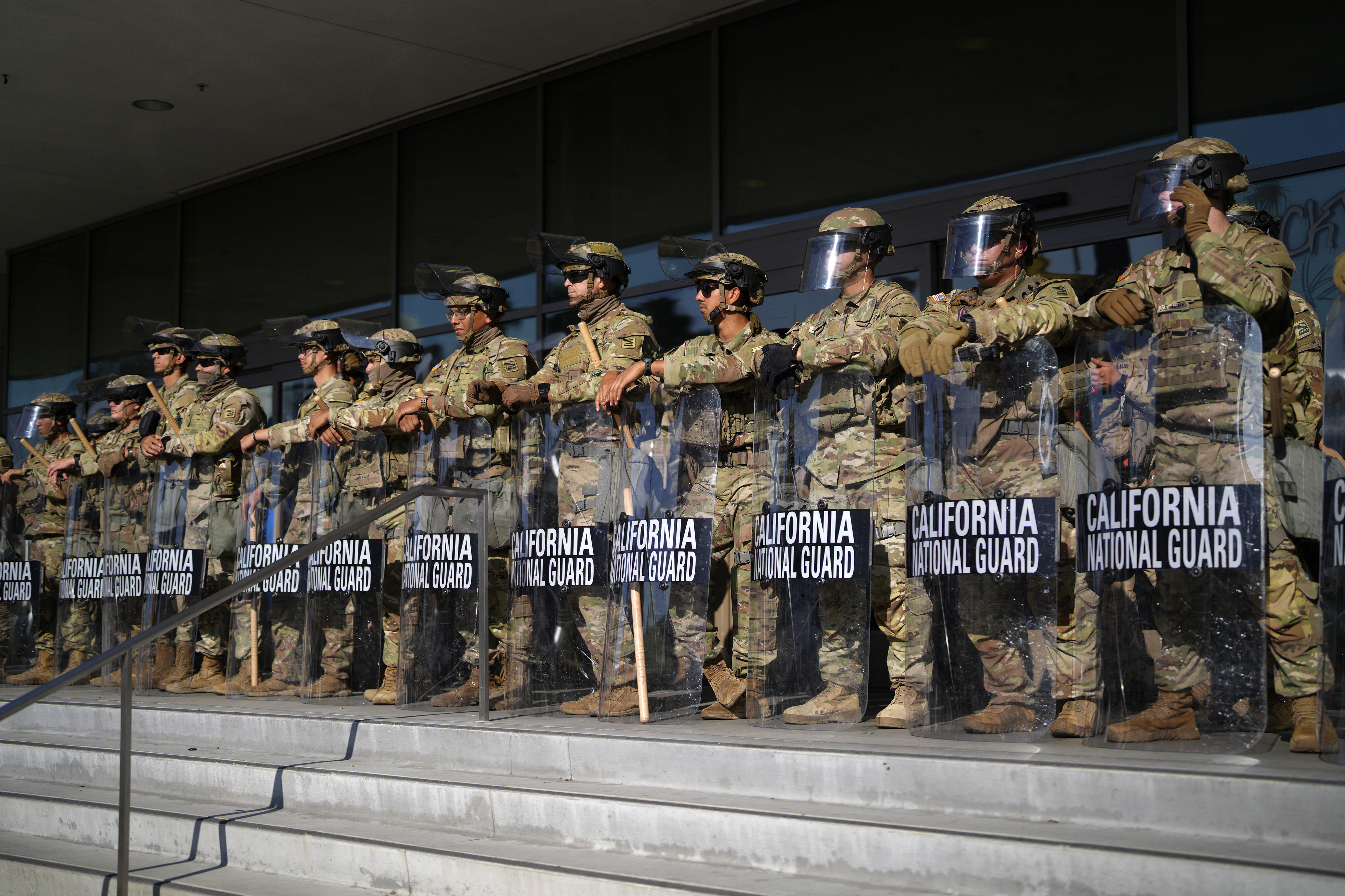 California National Guard stand in formation guarding the federal building in downtown Los Angeles on Tuesday, June 10, 2025. (AP Photo/Eric Thayer)