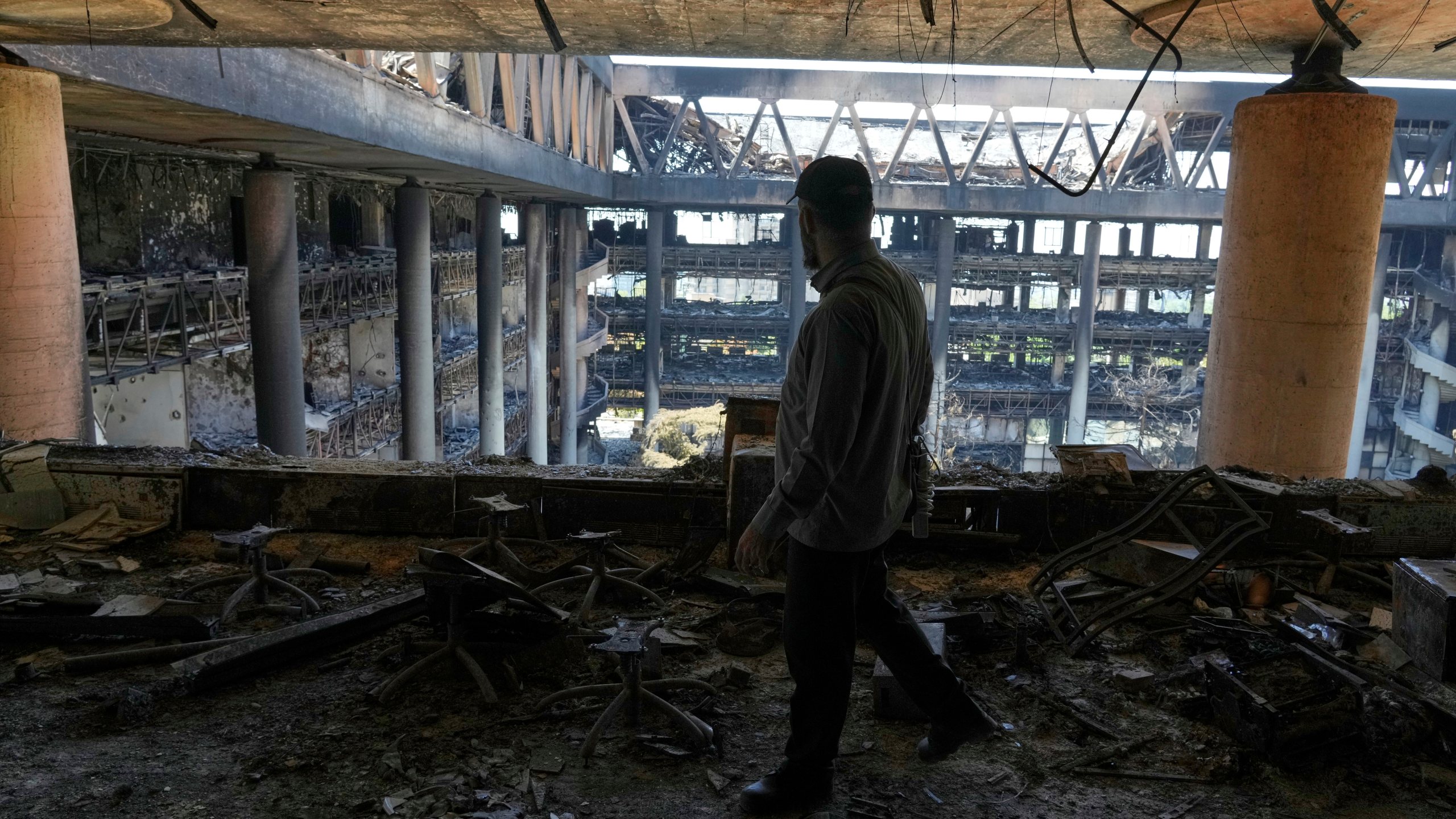 A man walks in the damaged headquarters of Islamic Republic of Iran Broadcasting, Iranian state television, in Tehran, Iran, Thursday, June 19, 2025. (AP Photo/Vahid Salemi)