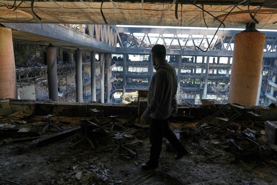 A man walks in the damaged headquarters of Islamic Republic of Iran Broadcasting, Iranian state television, in Tehran, Iran, Thursday, June 19, 2025. (AP Photo/Vahid Salemi)