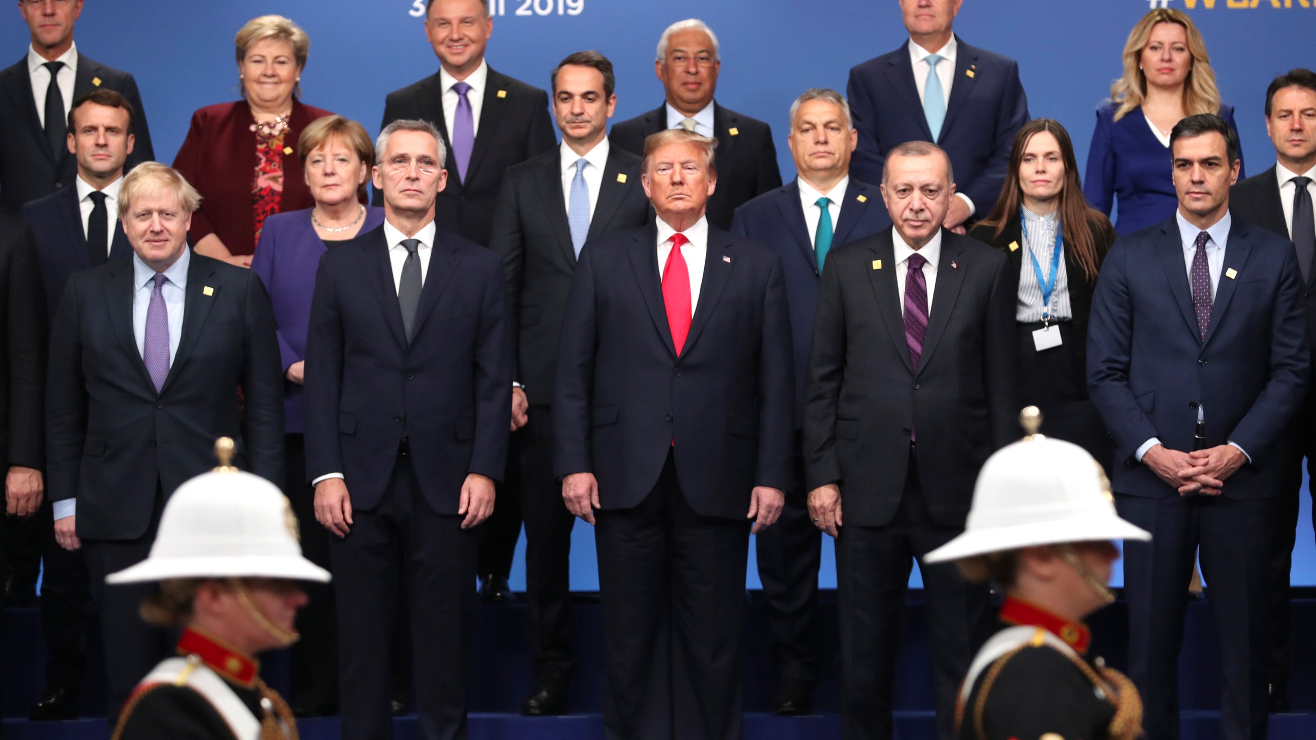 FILE - In this Dec. 4, 2019, photo, from front row left, British Prime Minister Boris Johnson, NATO Secretary General Jens Stoltenberg, U.S. President Donald Trump, Turkish President Recep Tayyip Erdogan and Spanish Prime Minister Pedro Sanchez attend a ceremony event during a NATO leaders meeting at The Grove hotel and resort in Watford, Hertfordshire, England. (AP Photo/Francisco Seco, File)