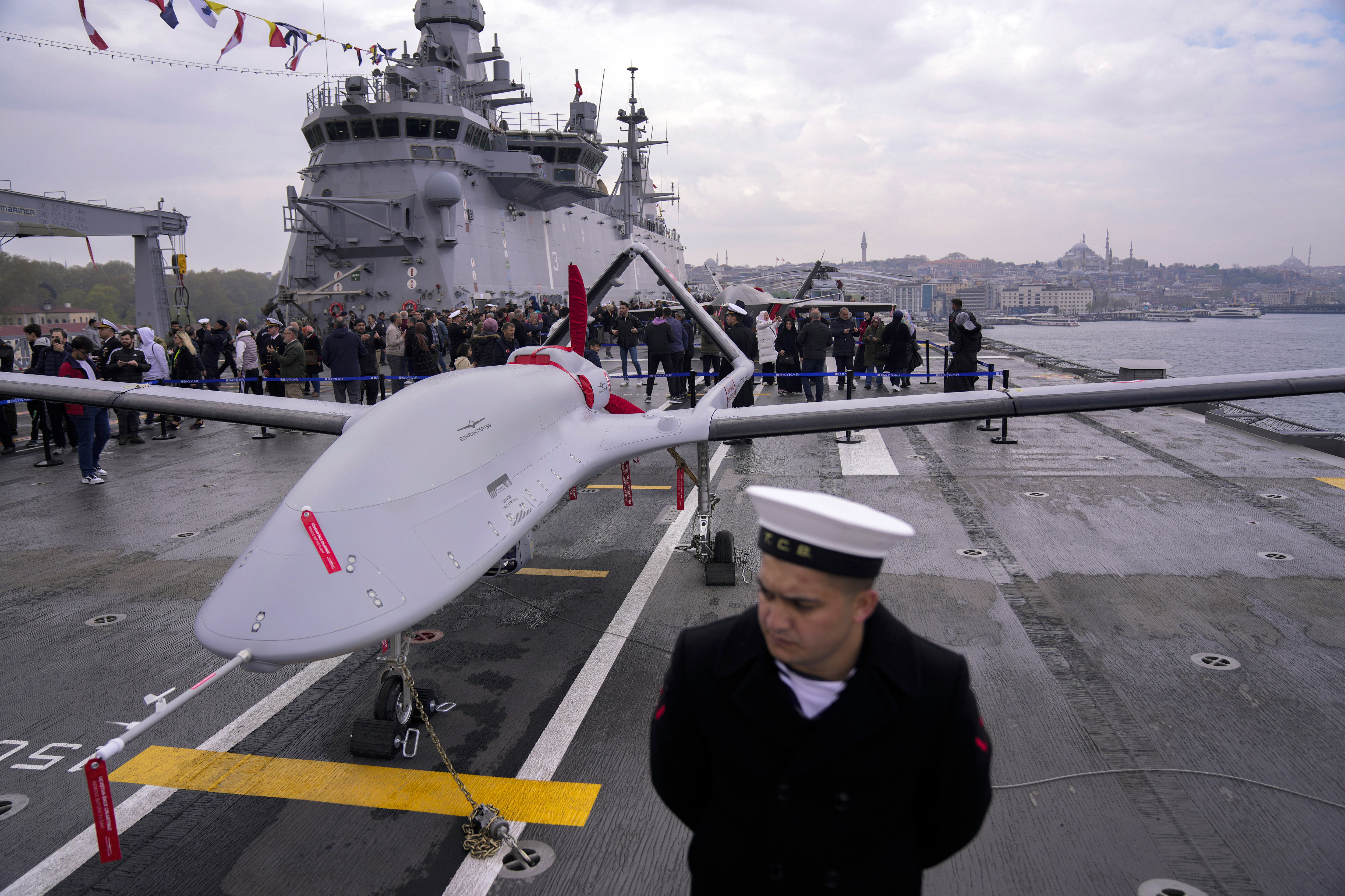 FILE - A navy soldier stands next to an unmanned combat aerial vehicle (UCAV) Bayraktar TB3 on board the Turkish amphibious assault ship TCG Anadolu L400, anchored in Istanbul, Turkey, Thursday, April 20, 2023. (AP Photo/Francisco Seco, File)