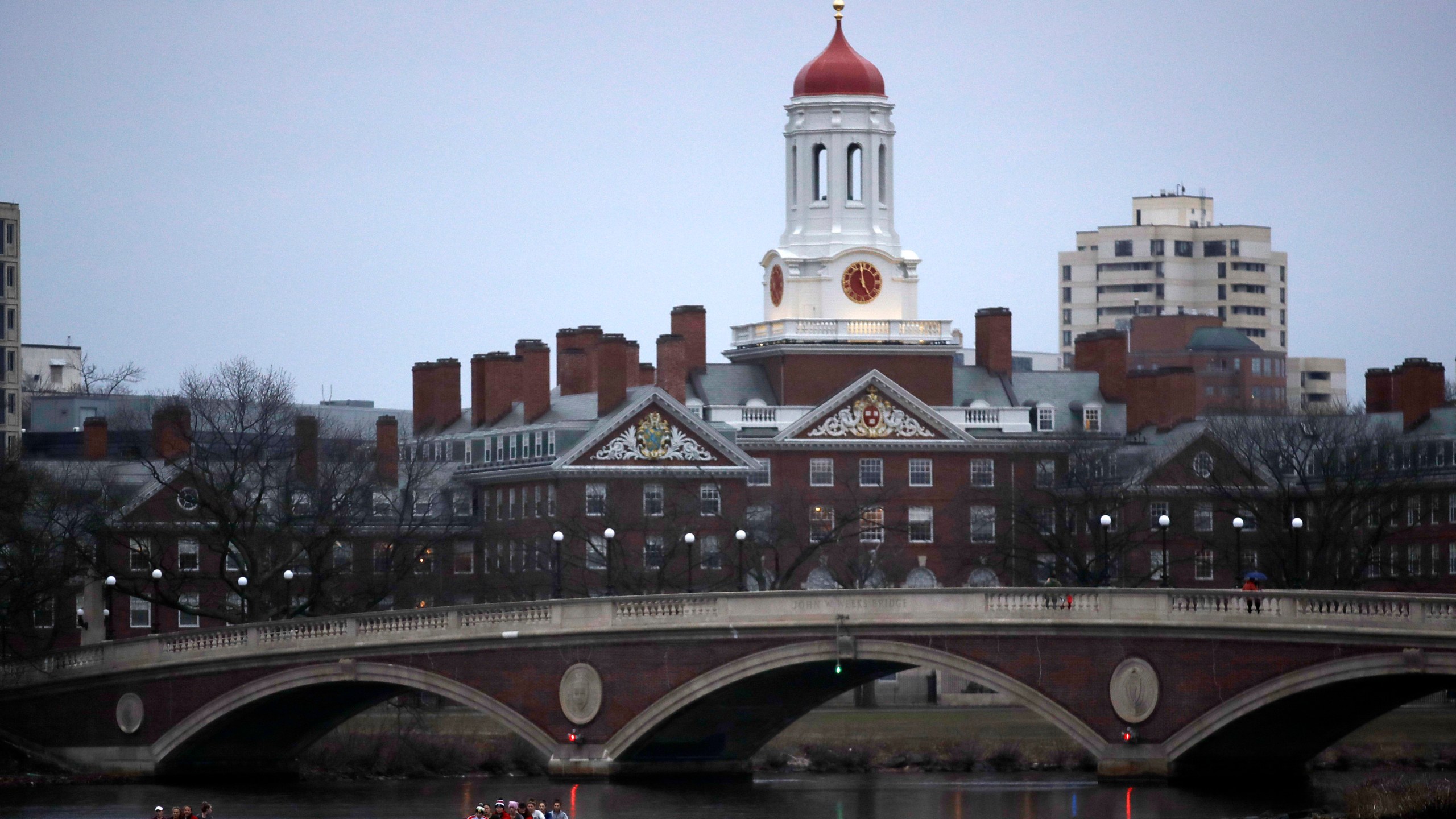 FILE - Rowers paddle down the Charles River near the campus of Harvard University in Cambridge, Mass., March 7, 2017. (AP Photo/Charles Krupa, File)