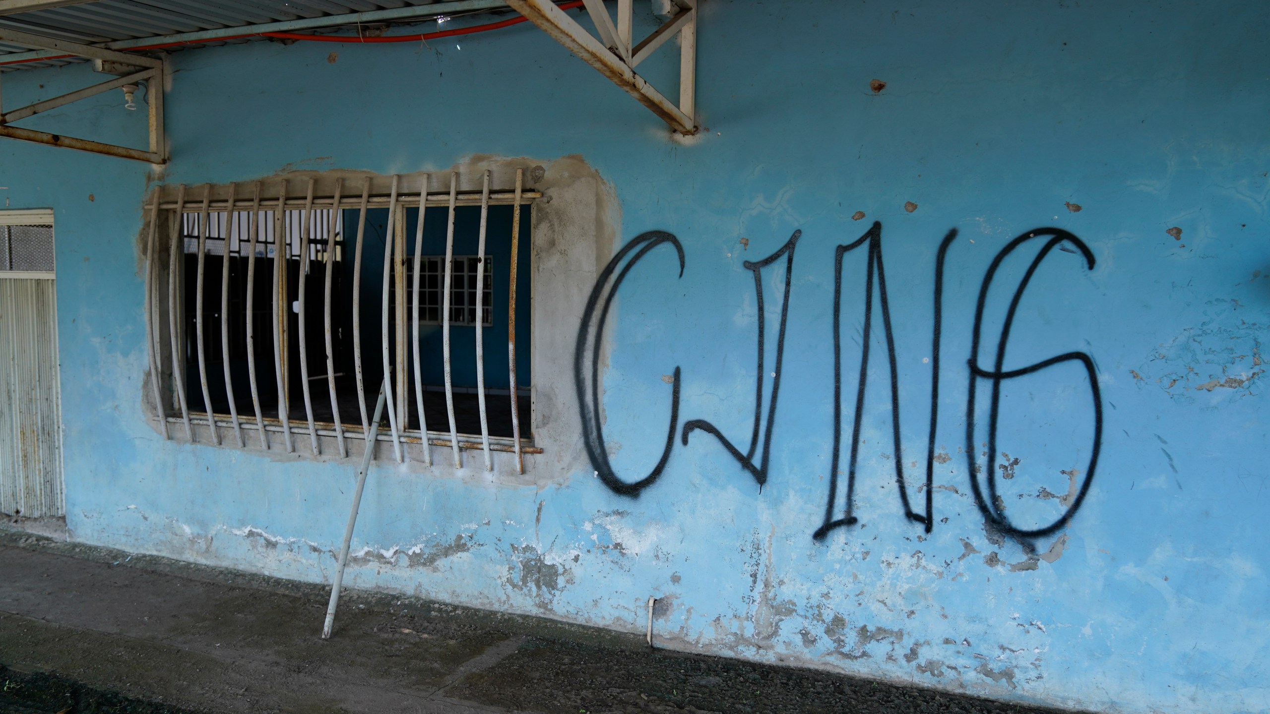FILE - The letters "CJNG" for the group's formal name, Jalisco New Generation Cartel, covers the facade of an abandoned home in El Limoncito, in the Michoacan state of Mexico, Oct. 30, 2021. (AP Photo/Eduardo Verdugo, File)