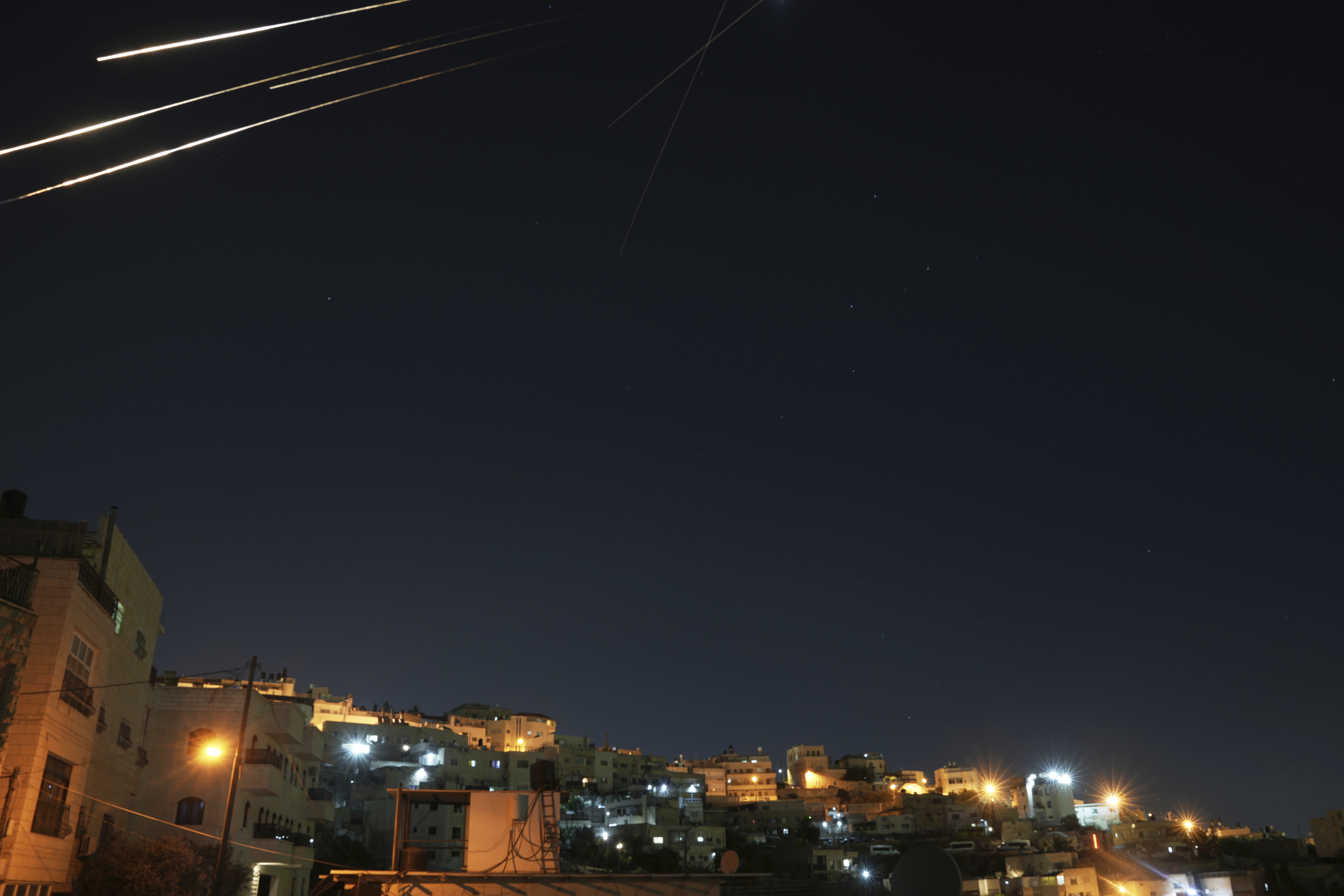 Missiles seen from Jerusalem illuminate the night sky during an Iranian missile attack, early Sunday, June 15, 2025. (AP Photo/Mahmoud Illean)