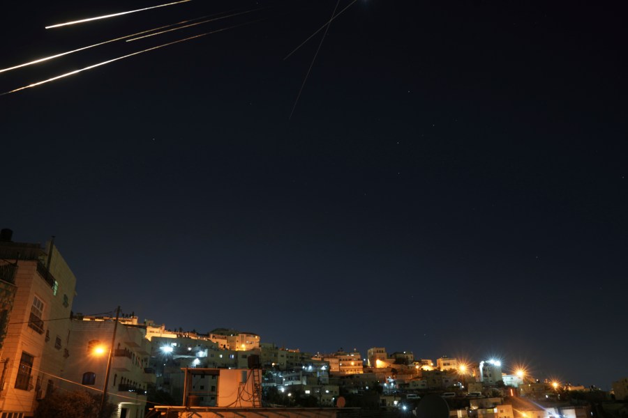 Missiles seen from Jerusalem illuminate the night sky during an Iranian missile attack, early Sunday, June 15, 2025. (AP Photo/Mahmoud Illean)