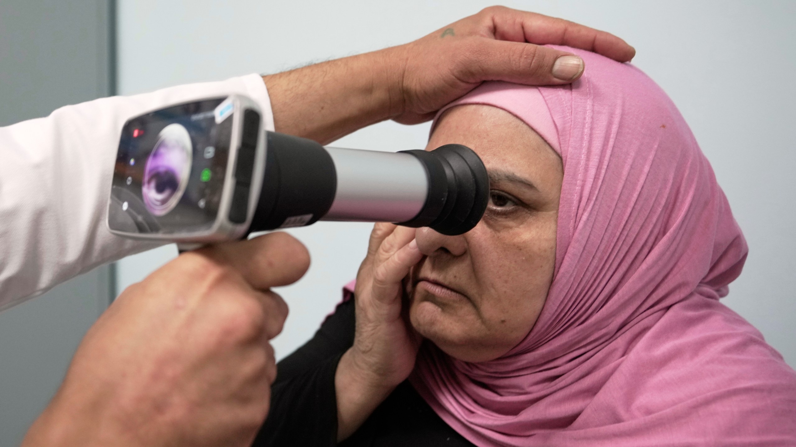 A Palestinian patient undergoes an eye examination at a medical center run by UNRWA in the Mar Elias refugee camp in Beirut, Lebanon, Monday, June 2, 2025. (AP Photo/Hassan Ammar)