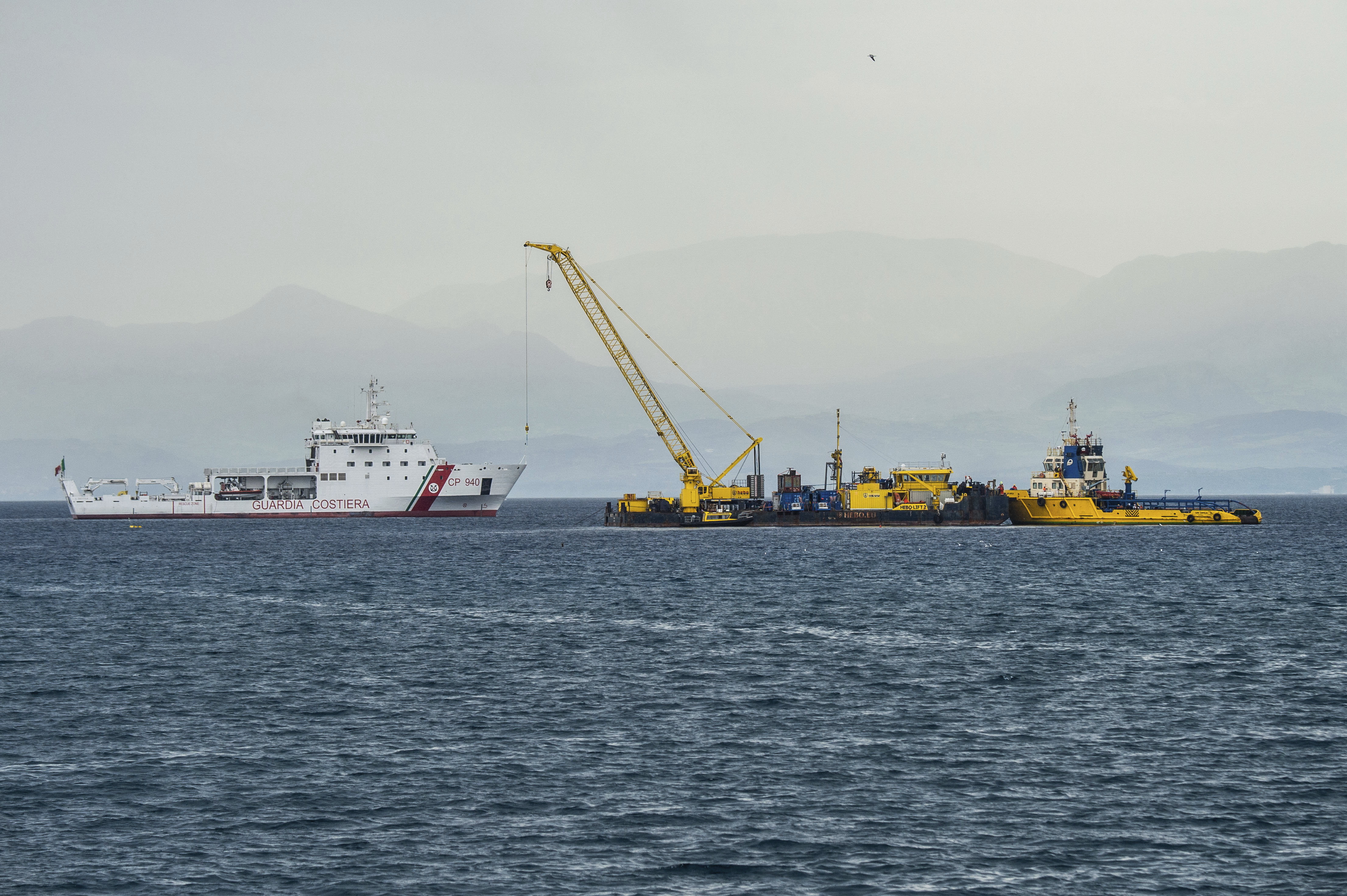 FILE - Italian Coast Guard's Luigi Dattilo patrol boat, left, assists the multi-purpose floating work barge Hebo Lift 2 monitoring the stretch of sea off Porticello, near Palermo, Sicily, Italy, Sunday, May 4, 2025, where the British superyacht Bayesian sunk on August 19, 2024 as the operations for its recovery start. (AP Photo/Salvatore Cavalli, File)