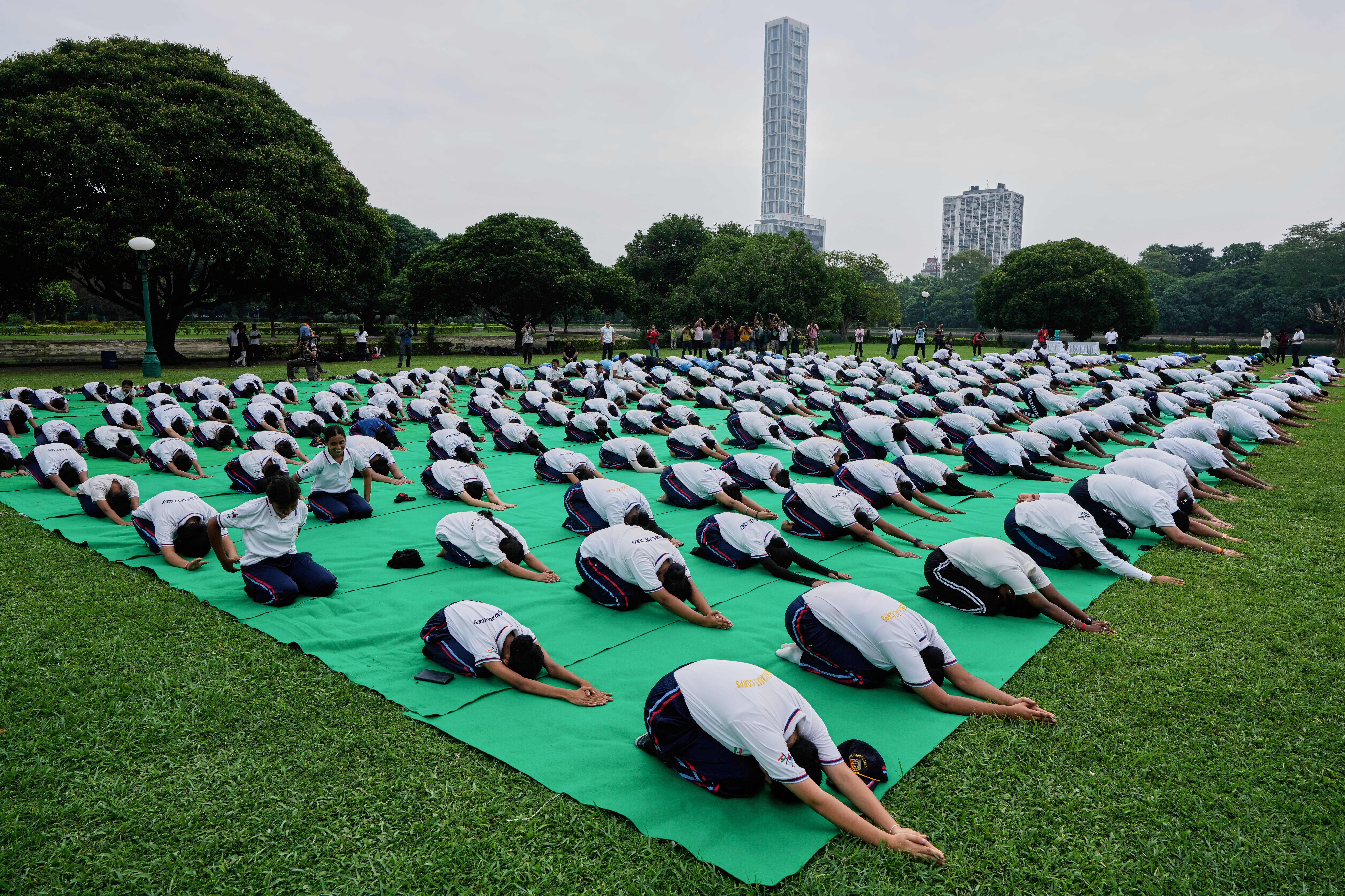 School boys and girls perform yoga on International Yoga Day at Victoria Memorial compound, in Kolkata, India, Saturday, June 21, 2025. (AP Photo/Bikas Das)