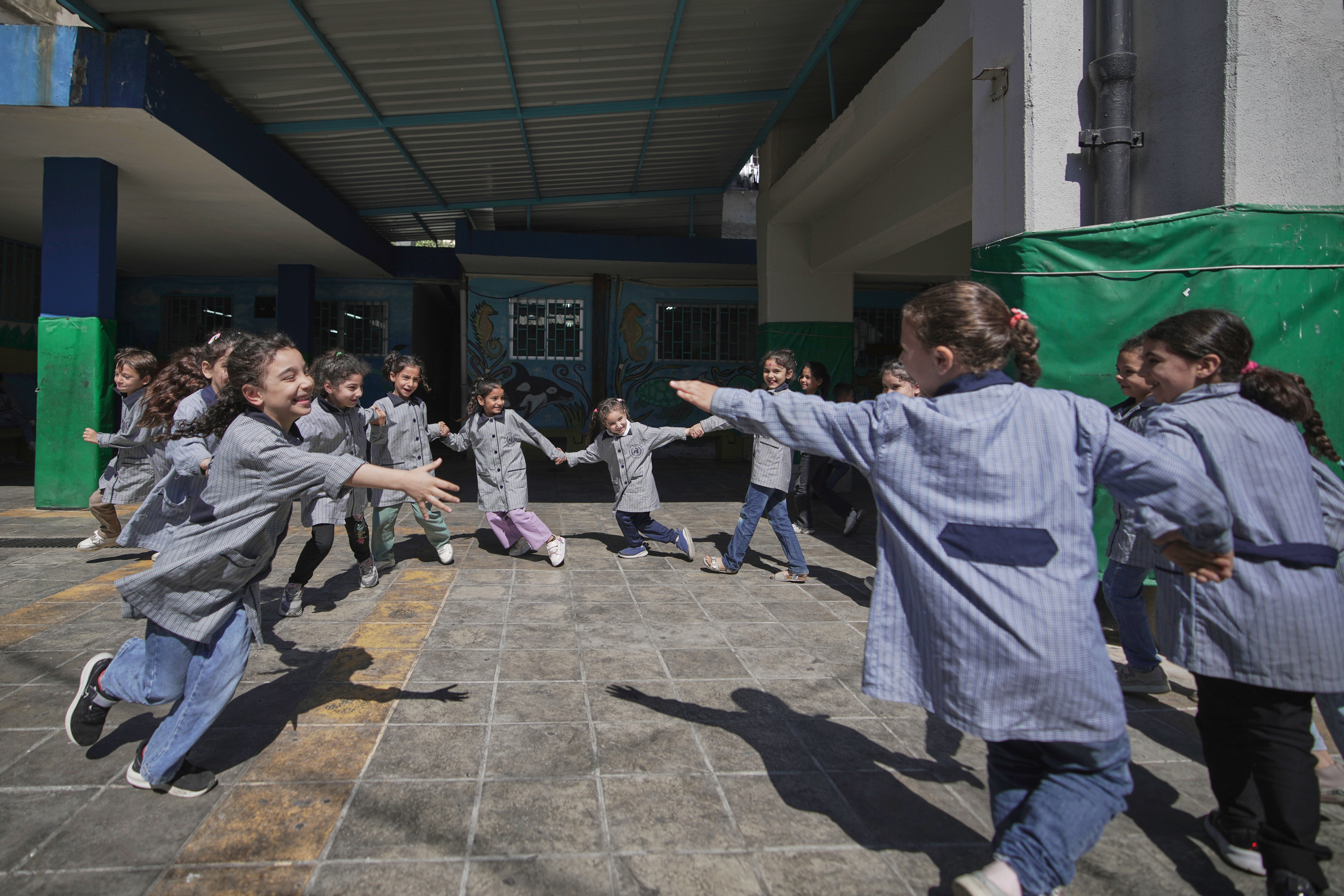 Students play in the courtyard of a primary school run by UNRWA for Palestinian refugees at the Mar Elias refugee camp in Beirut, Lebanon, Monday, June 2, 2025. (AP Photo/Hassan Ammar)