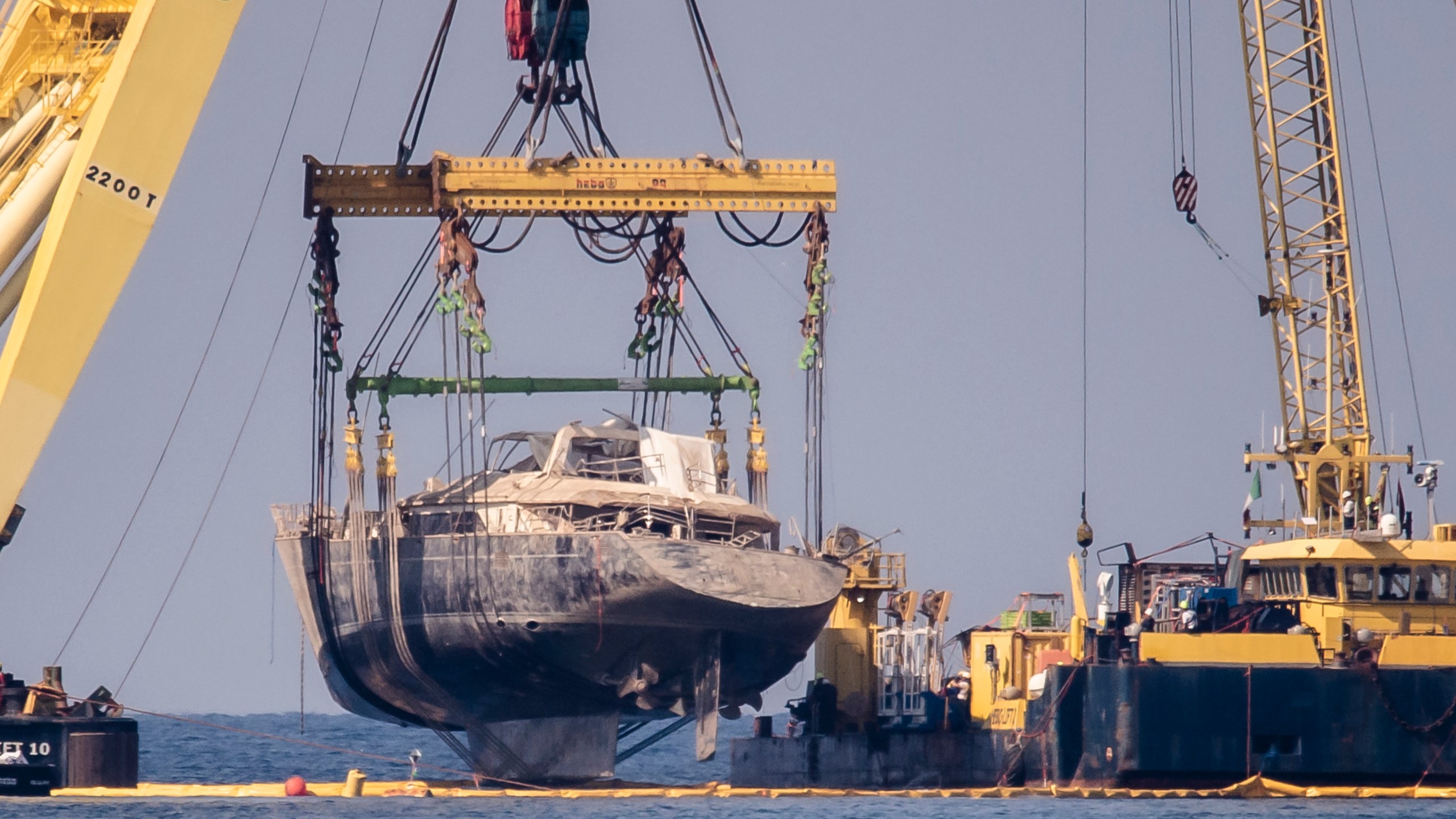 The hull of the superyacht Bayesian, which sank near Palermo, Sicily, on August 19, 2024, is pulled out of the sea off the village of Porticello and dewatered, Saturday, June 21, 2025. (AP Photo/Salvatore Cavalli)